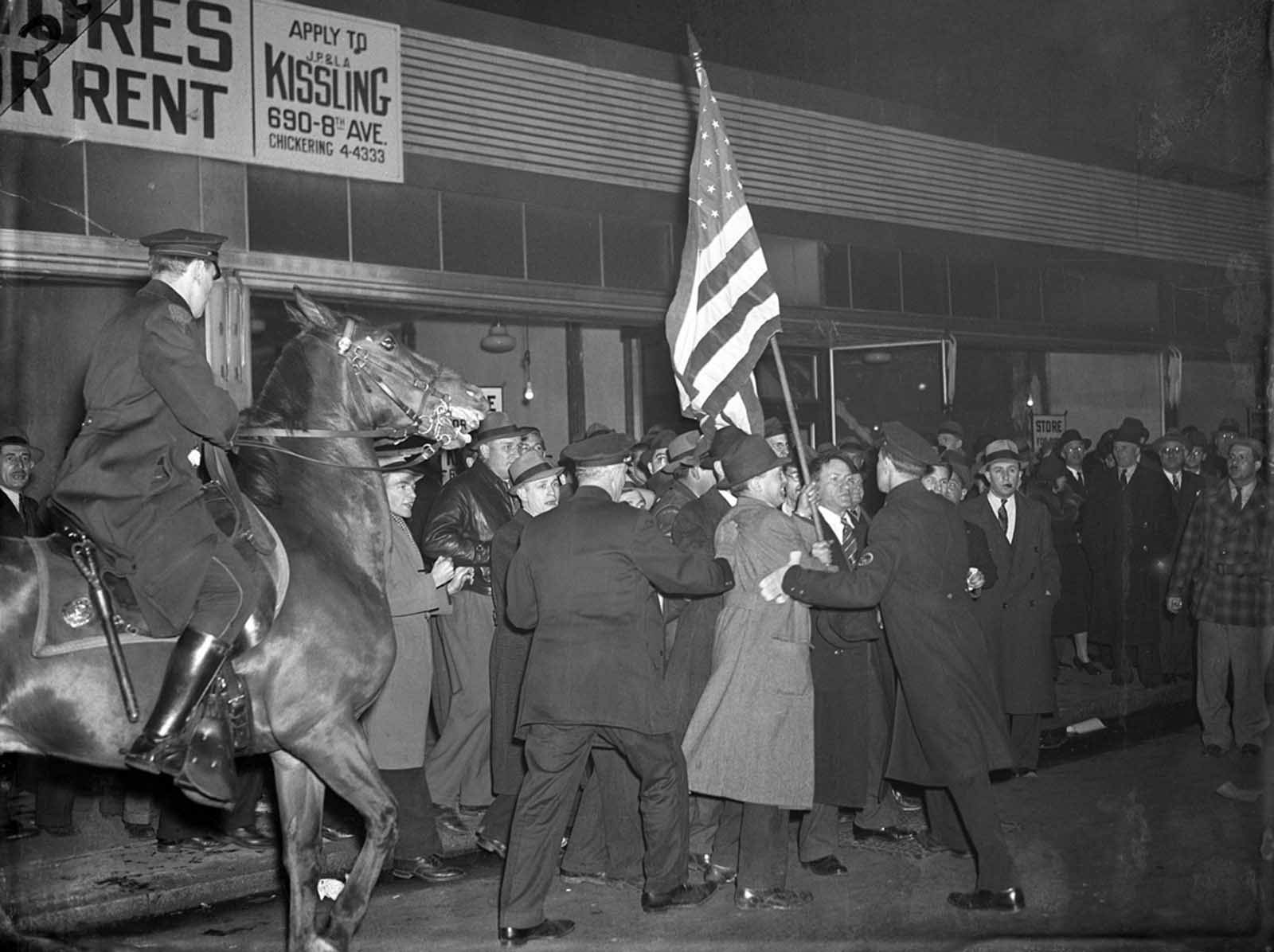 February 20, 1939. Original Caption: Fight For The Flag... Anti Nazis Battle Cops. Mounted Policemen and rabid Anti Nazis battle for an American flag outside Madison Square Garden. The Anti-Nazis were parading outside the Garden in protest of the German American Bund