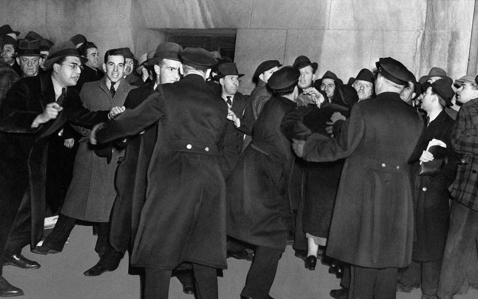 Original Caption: There’s plenty of pushing and shoving as police try to keep streets clear in the immediate vicinity of Madison Square Garden in New York, on February 20, 1939 during a German-American Bund rally which had aroused a storm of protest from anti-Bund forces. There were strict police orders against picketing, and the 1,500 cops on duty in the area were instructed to halt all persons entering the neighborhood with provocative signs.