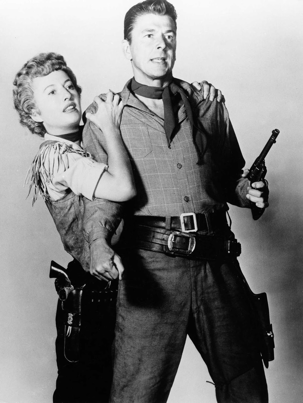Reagan and Barbara Stanwyck pose for a promo still for Cattle Queen of Montana. 1954.