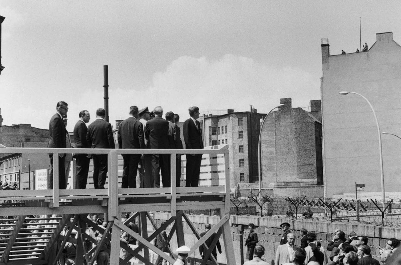 Kennedy surveys the Berlin Wall from a special viewing platform.