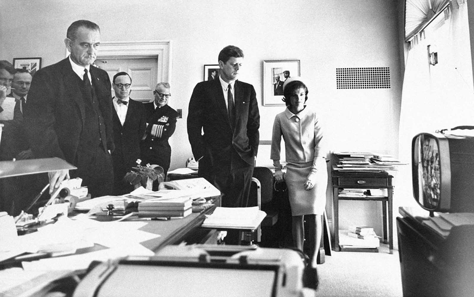 President Kennedy and Mrs. Jacqueline Kennedy follow the takeoff and space flight of Astronaut Alan Shepard on television. Others, watching from the White House office of the Chief Executive's secretary in Washington, on May 5, 1961, are, from left: Attorney General Robert Kennedy; McGeorge Bundy, presidential assistant; Vice President Lyndon Johnson; Arthur Schlesinger Jr., another presidential assistant, and Chief of Naval Operations Adm. Arleigh Burke.