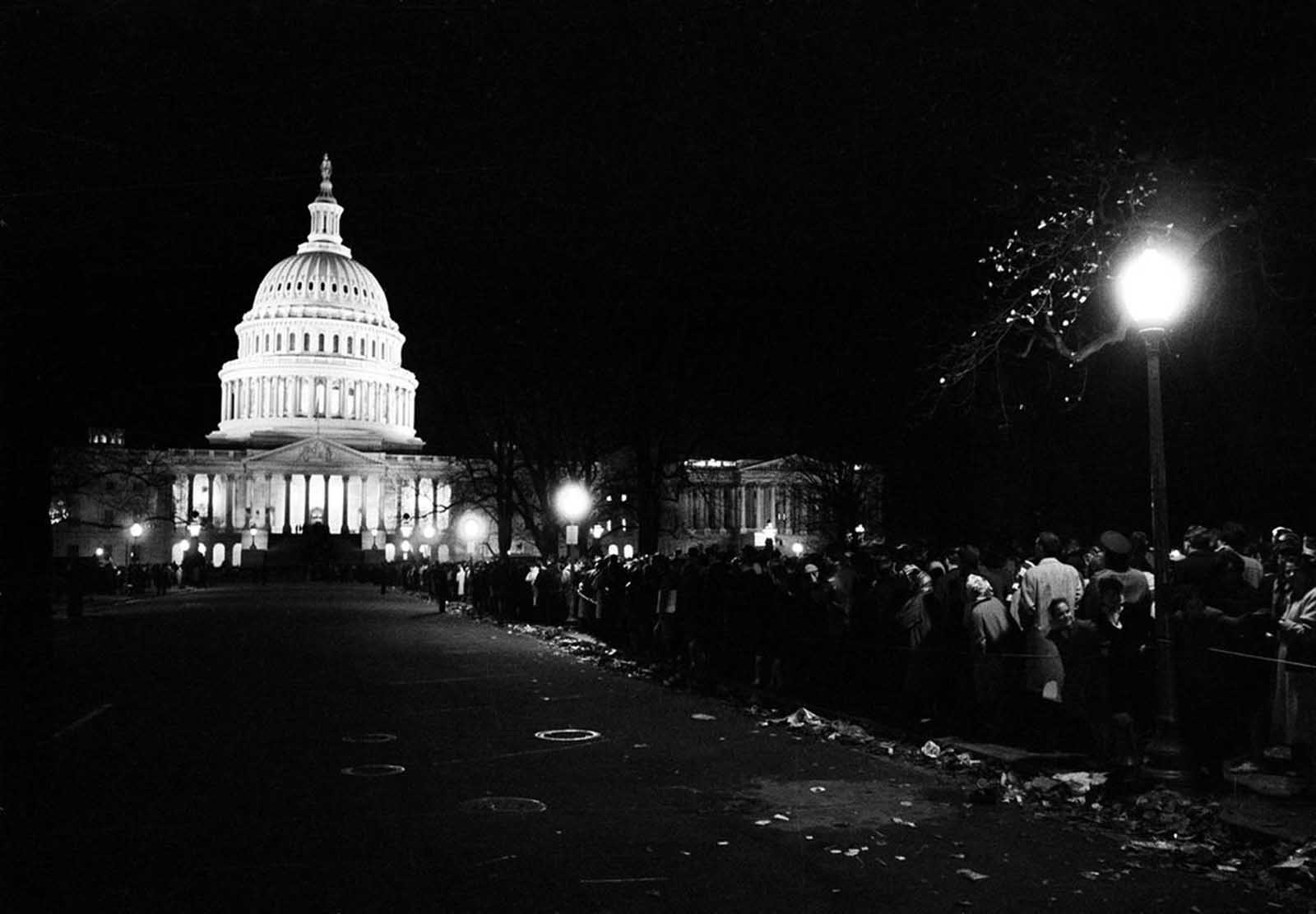 With the illuminated U.S. Capitol in the background, mourners form an endless line which lasted through the night, to pay their respects to the slain President John F. Kennedy, in Washington, District of Columbia, on November 24, 1963.