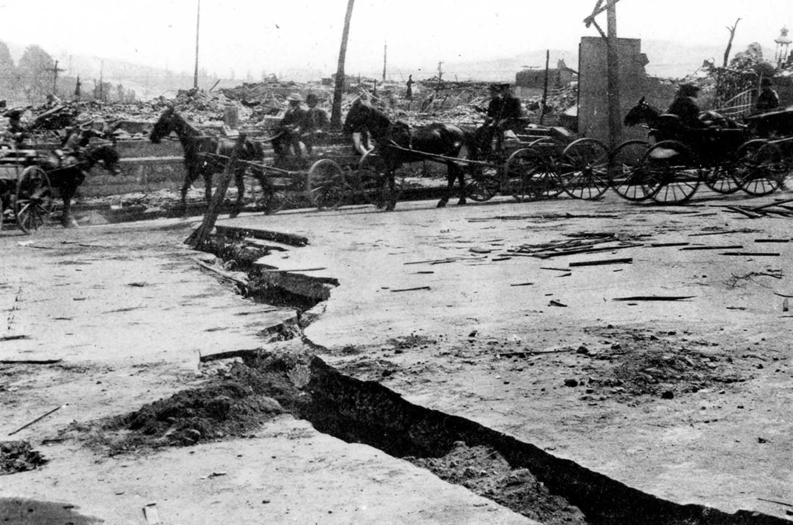 Disruption of Van Ness Avenue over a filled-in ravine. Original caption: “Break in asphalt paving on Van Ness Avenue near Vallejo Street. View shows horse-drawn wagon and buggy traffic.”