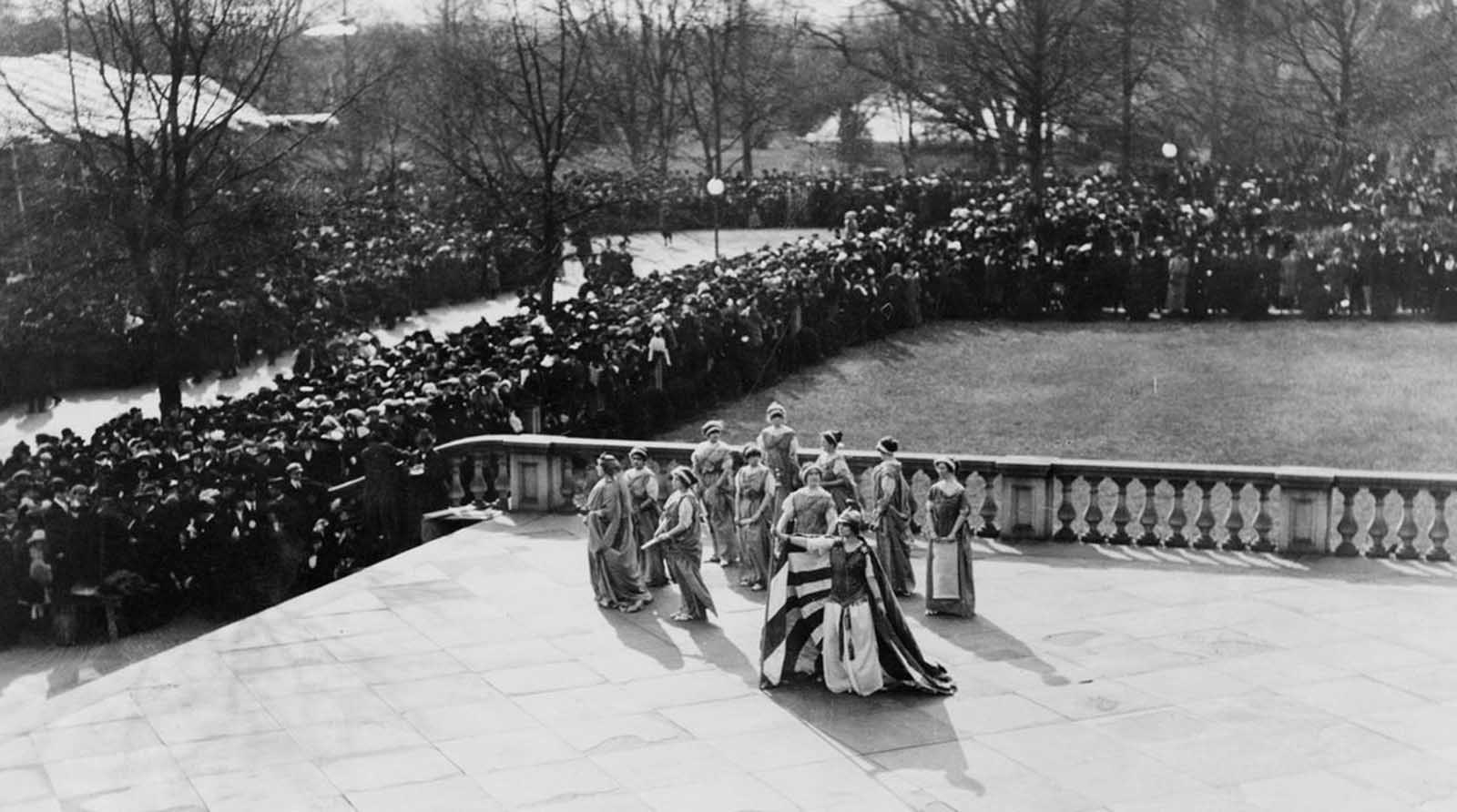 Tableau presented by the Women's Suffrage Association, on the U.S. Treasury building steps, on March 3, 1913.