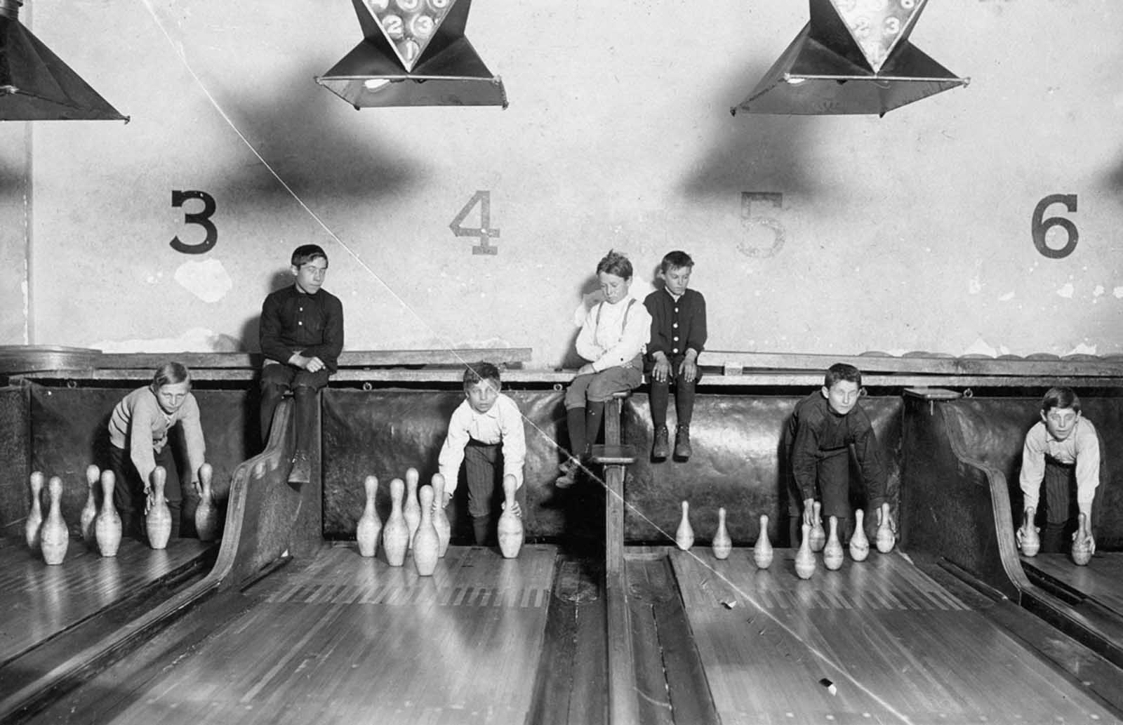 Pin-boys work in the Arcade Bowling Alley in Trenton, New Jersey, on December 20, 1909. The boys worked until midnight and later.