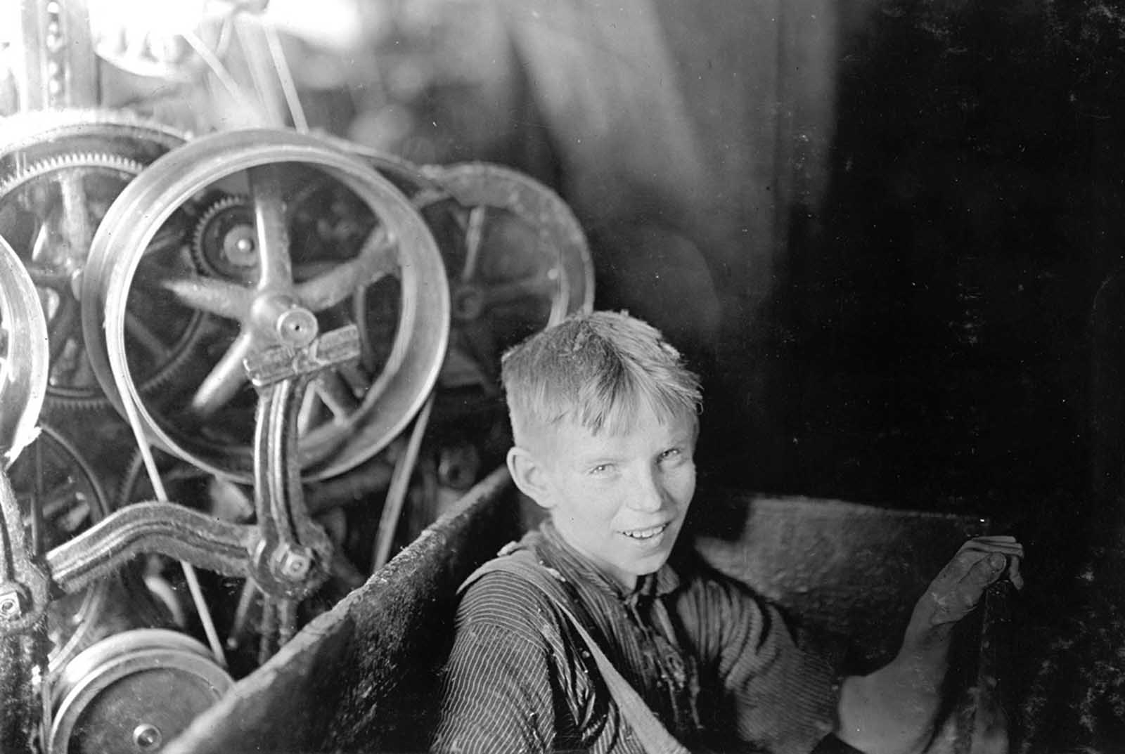 Willie, one of the young spinners in the Quidwick Co. Mill in Anthony, Rhode Island. He was taking his noon rest in a doffer-box on this day in April of 1909.