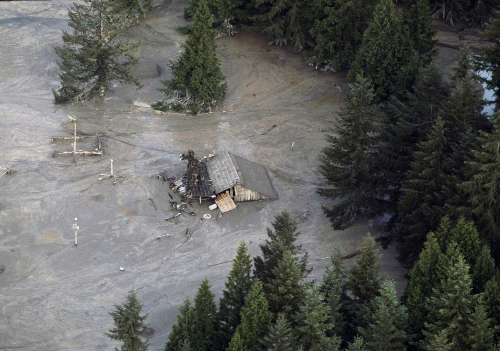A house is submerged along the Toutle River which flooded in the aftermath of the eruption of Mount St. Helens on May 19, 1980. Area streams and rivers rose quickly as ice and snow on the volcano melted instantly.