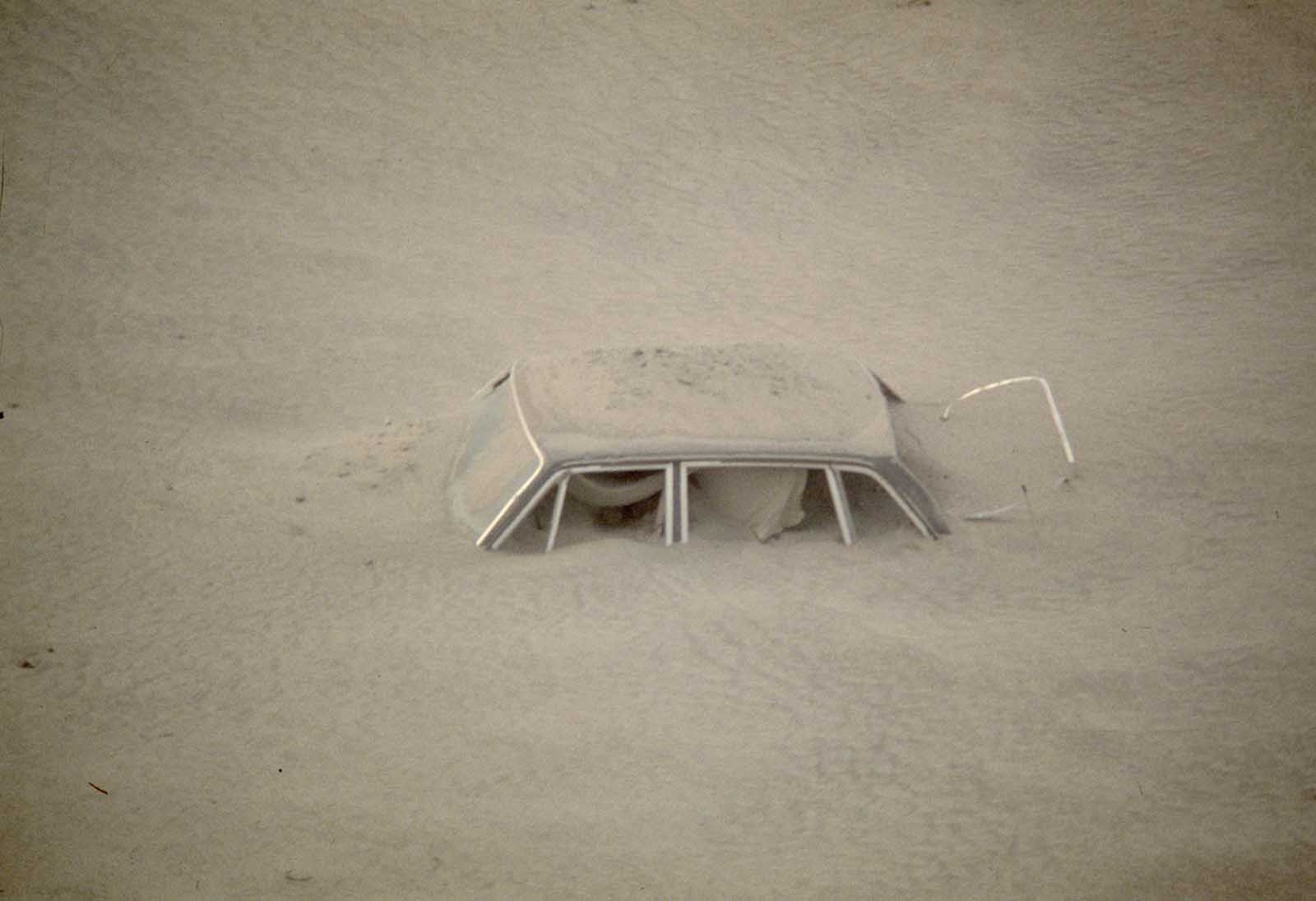 A car sits submerged in ash in this May 20, 1980 photo from the Mount St. Helen eruption in Washington State.