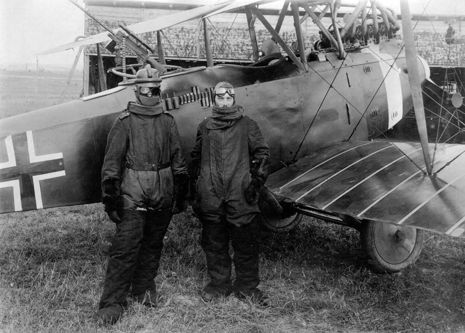 German pilot Richard Scholl and his co-pilot Lieutenant Anderer, in flight gear beside their Hannover CL.II biplane in 1918.