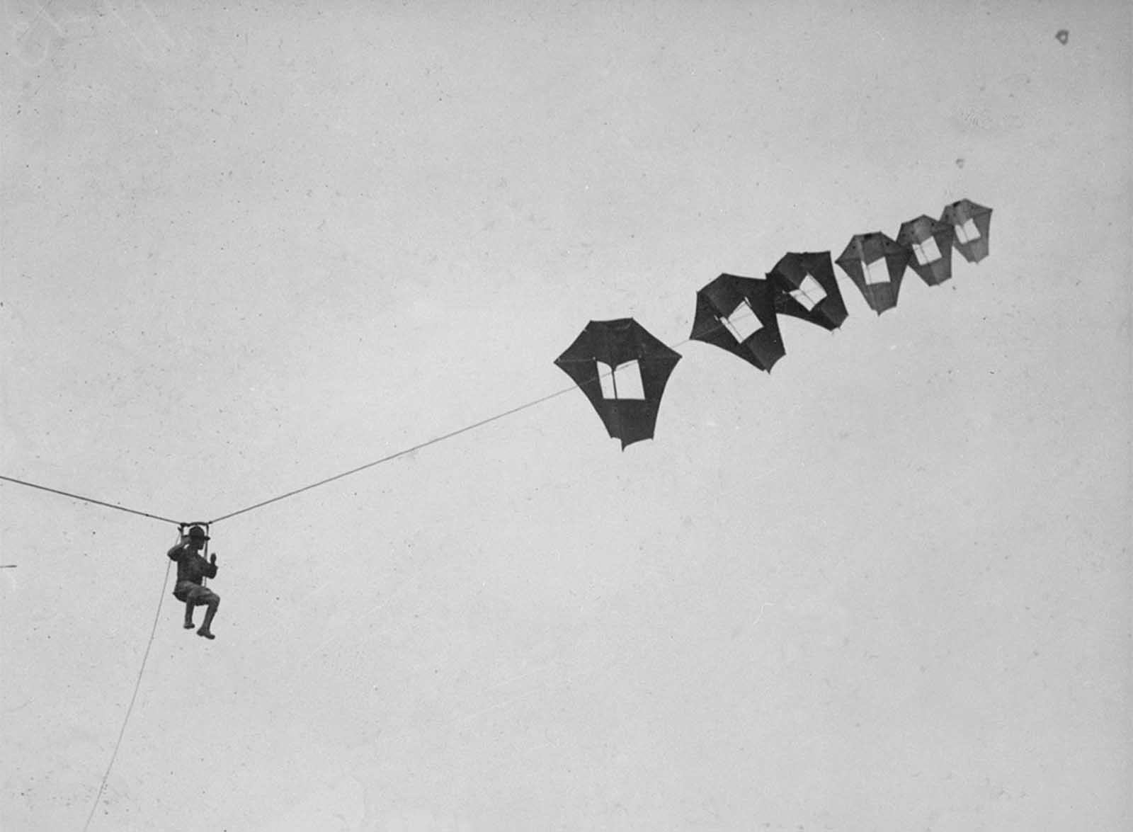 Lieutenant Kirk Booth of the U.S. Signal Corps being lifted skyward by the giant Perkins man-carrying kite at Camp Devens, Ayer, Massachusetts. While the United States never used these kites during the war, the German and French armies put some to use on the front lines.