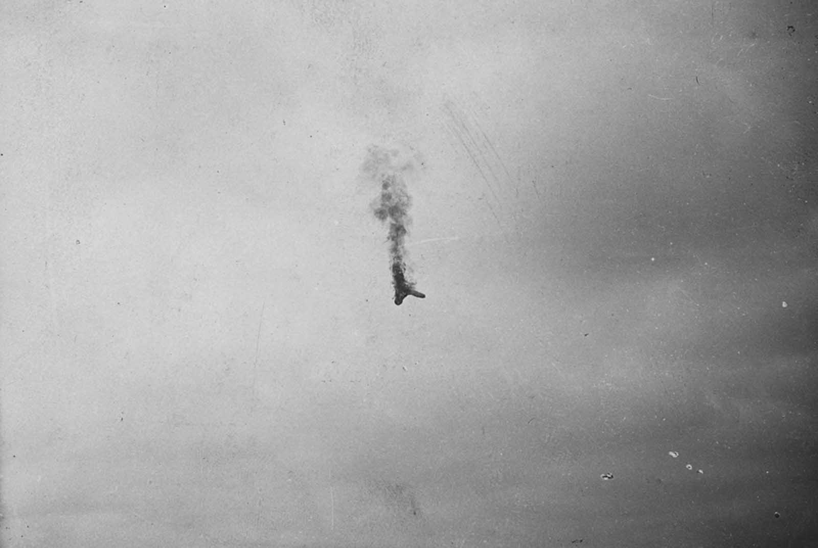 An aircraft in flames falls from the sky.