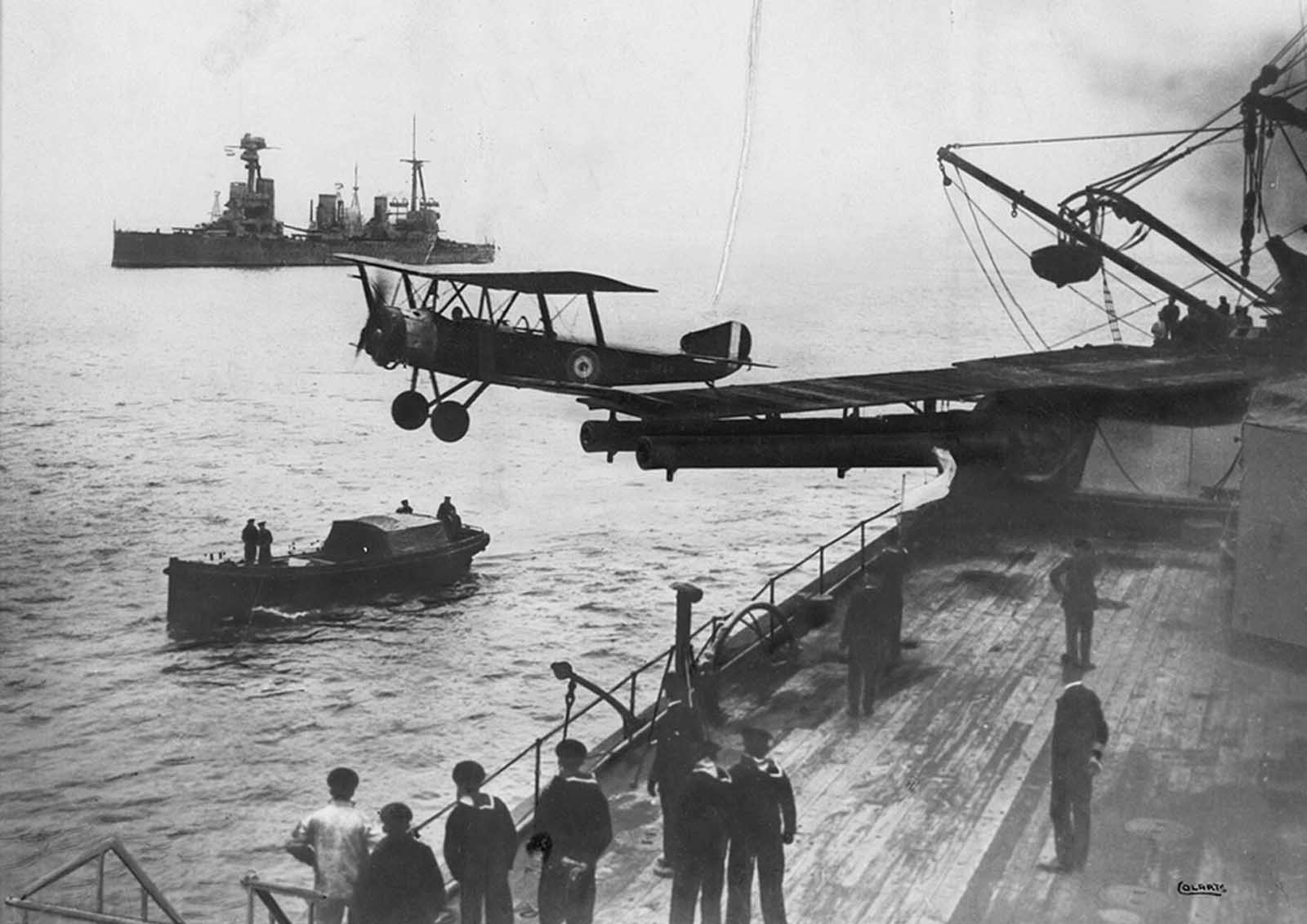 A Sopwith 1 1/2 Strutter biplane aircraft taking off from a platform built on top of HMAS Australia's midships 