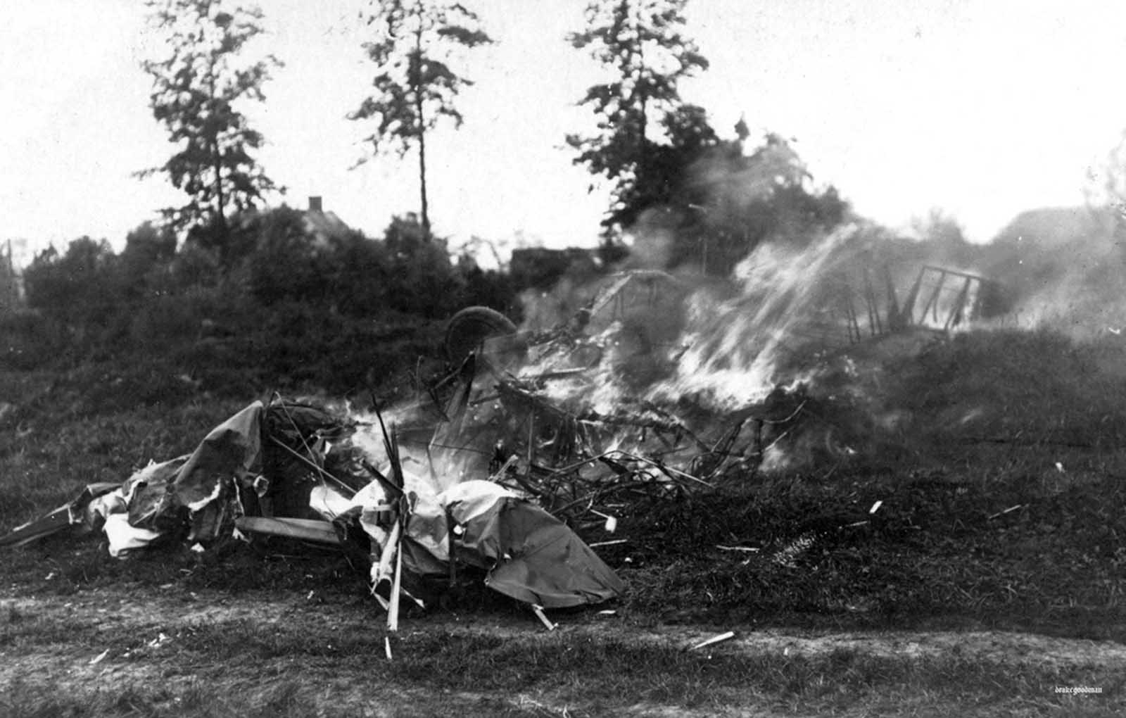 An aircraft. crashed and burning in German territory, ca. 1917.