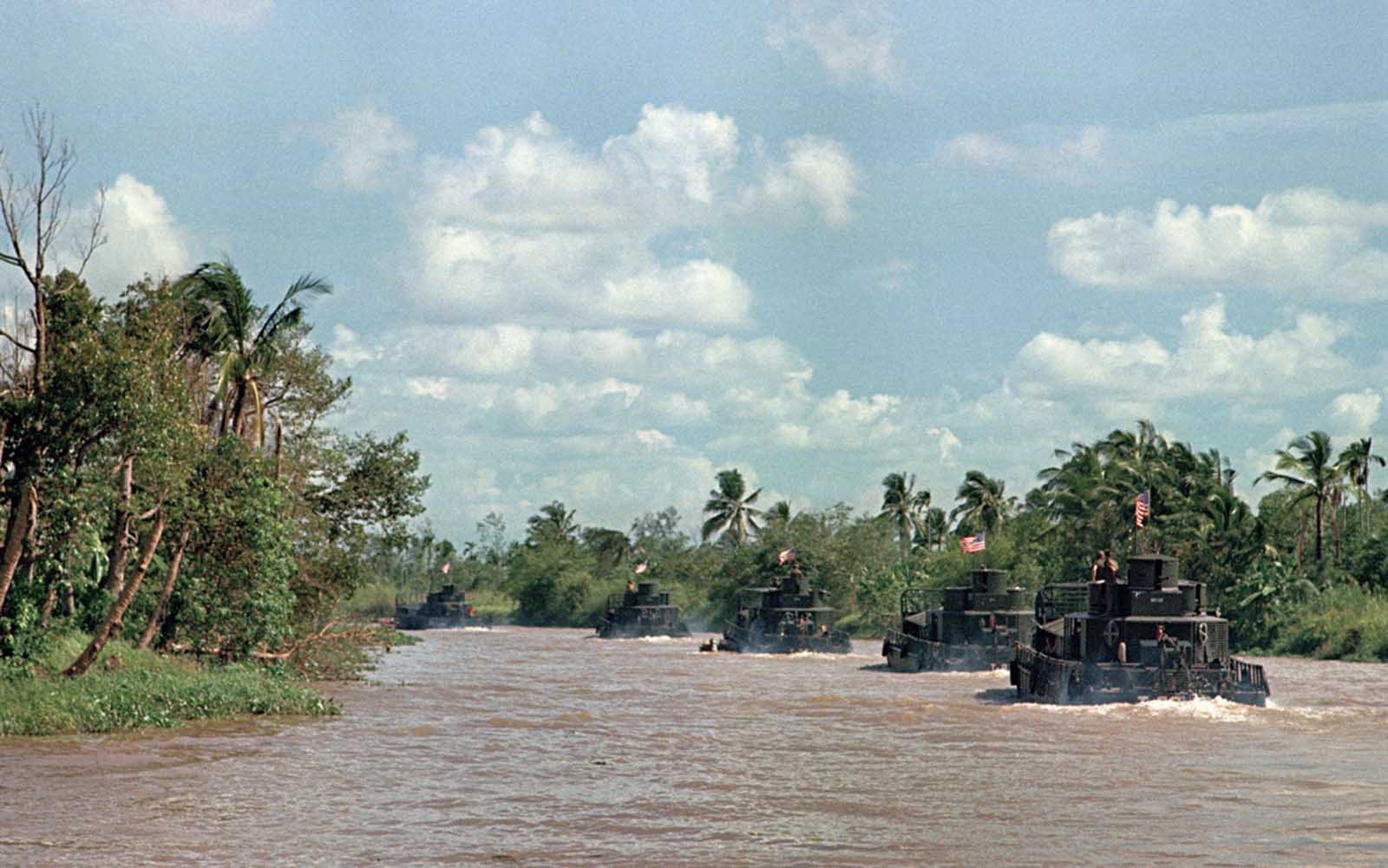 Assault boats in the Mobile Riverine Force of the U.S. 9th Infantry Division glide along the My Tho River, an arm of the Mekong Delta near Dong Tam, 35 miles southwest of Saigon, on March 15, 1968.