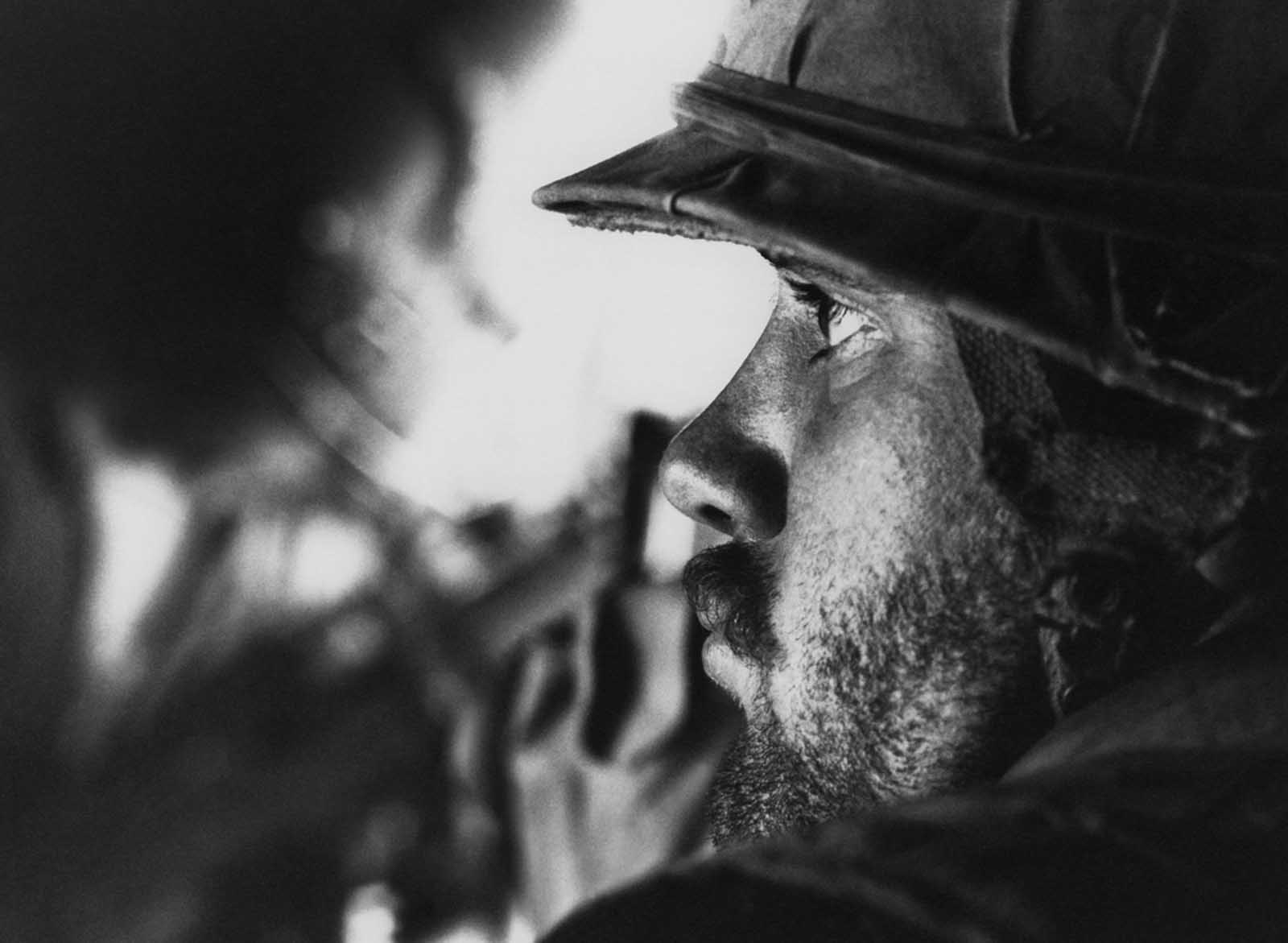 A U.S Marine with several days of beard growth sits in a helicopter after being picked up from the landing zone near Con Thein on the southern edge of the demilitarized zone in South Vietnam on July 18, 1968. His unit had just been relieved of duty after patrolling the region around the DMZ.