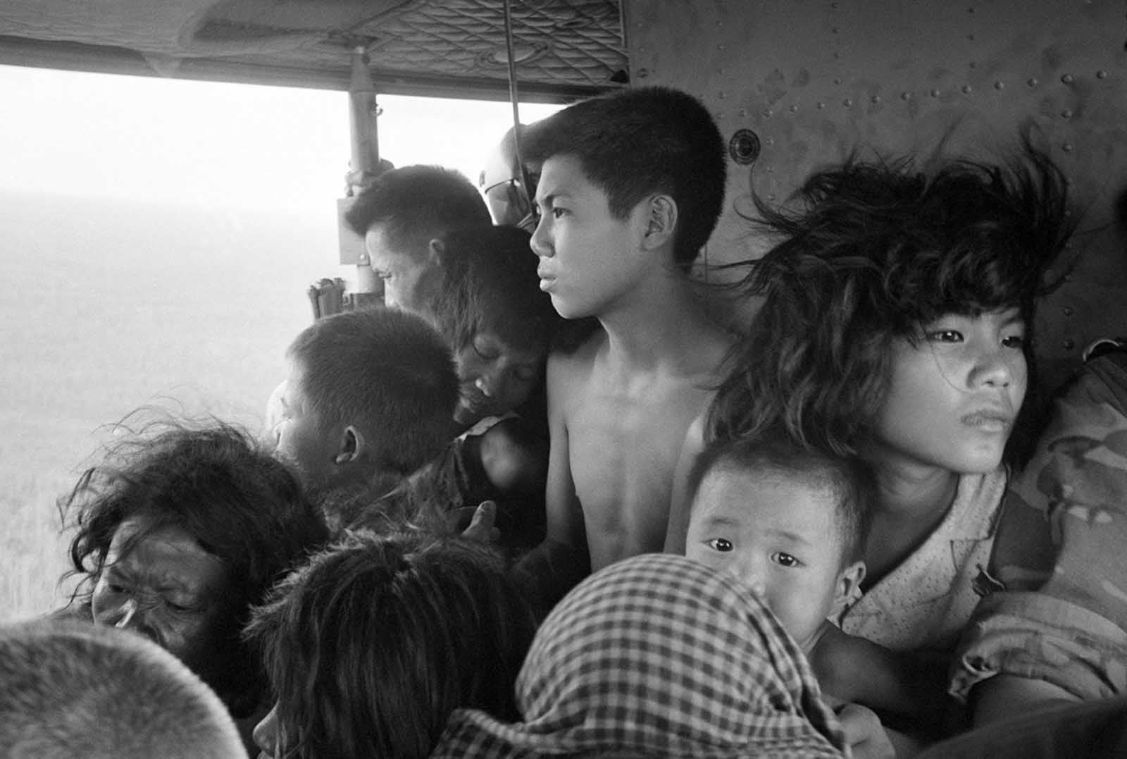 Vietnamese and Cambodian refugees crowd a U.S. helicopter which evacuated them from immediate combat zone of the U.S.-Vietnamese incursion into Cambodia on May 5, 1970. They were taken to a refugee reception center at the Katum Special Forces camp in South Vietnam, six miles from the Cambodian border.