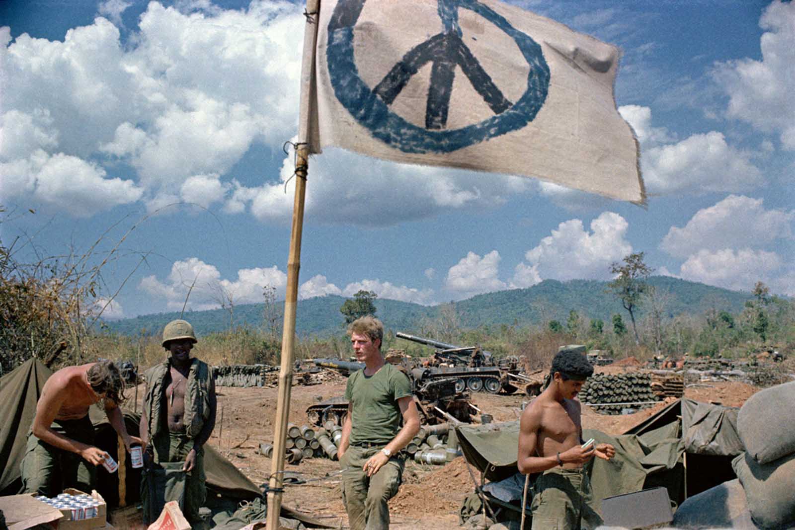 U.S. artillerymen relax under a crudely made peace flag at the Laotian border in 1971. The gunners were giving covering fire for South Vietnamese troops operating inside Laos.