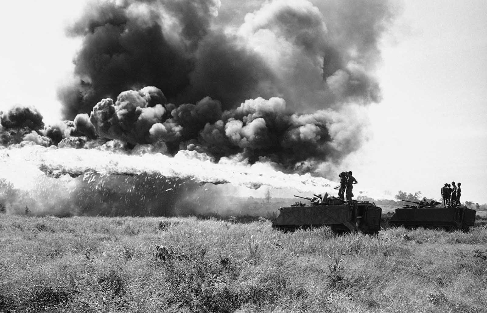 South Vietnamese troopers test fire flame throwers mounted atop APCs prior to moving out on operation west of Krek, Cambodia, on November 28, 1971.