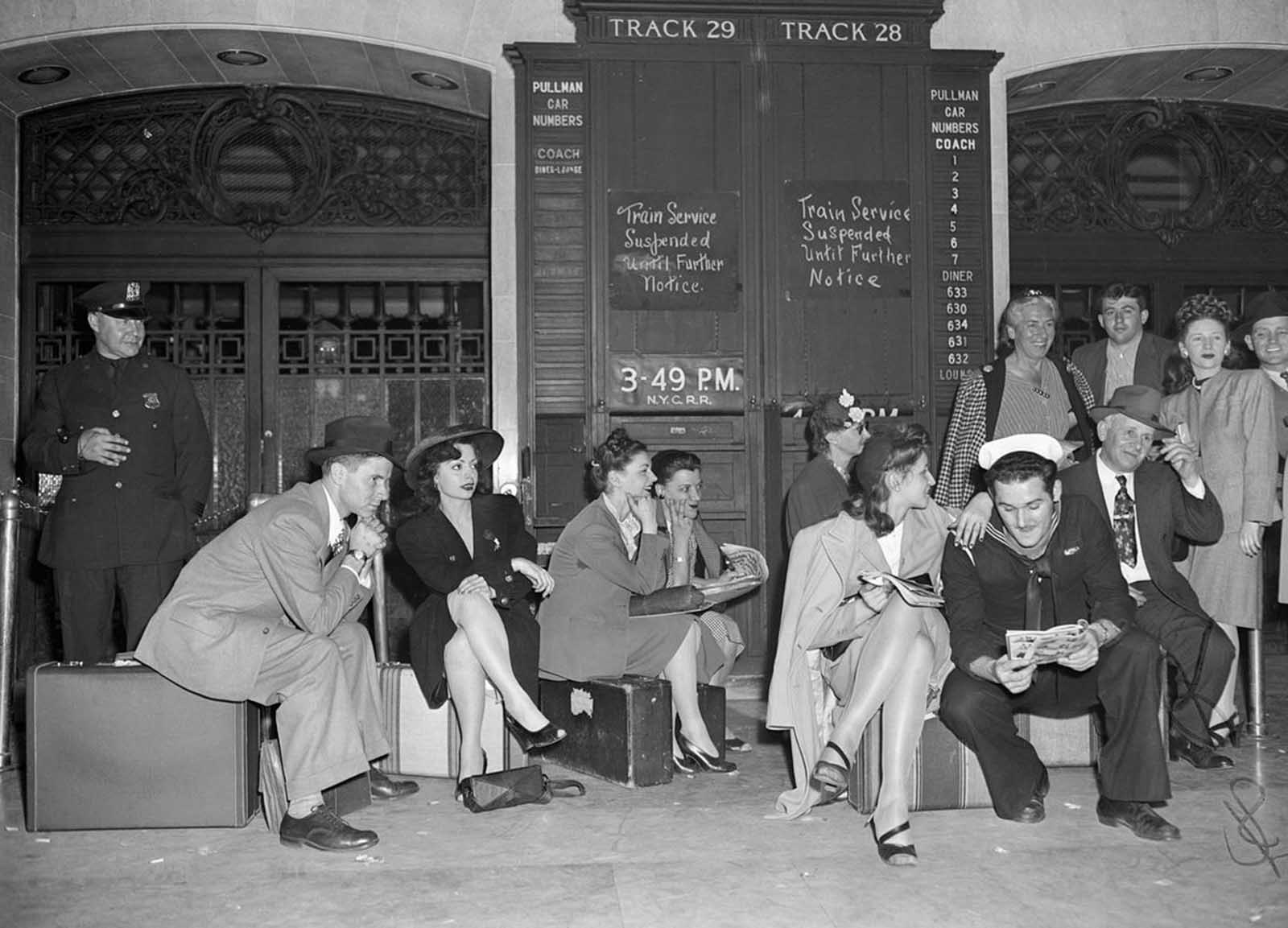 Would-be passengers sit on their luggage in Grand Central Terminal on May 23, 1946, where they were stranded by a rail strike.