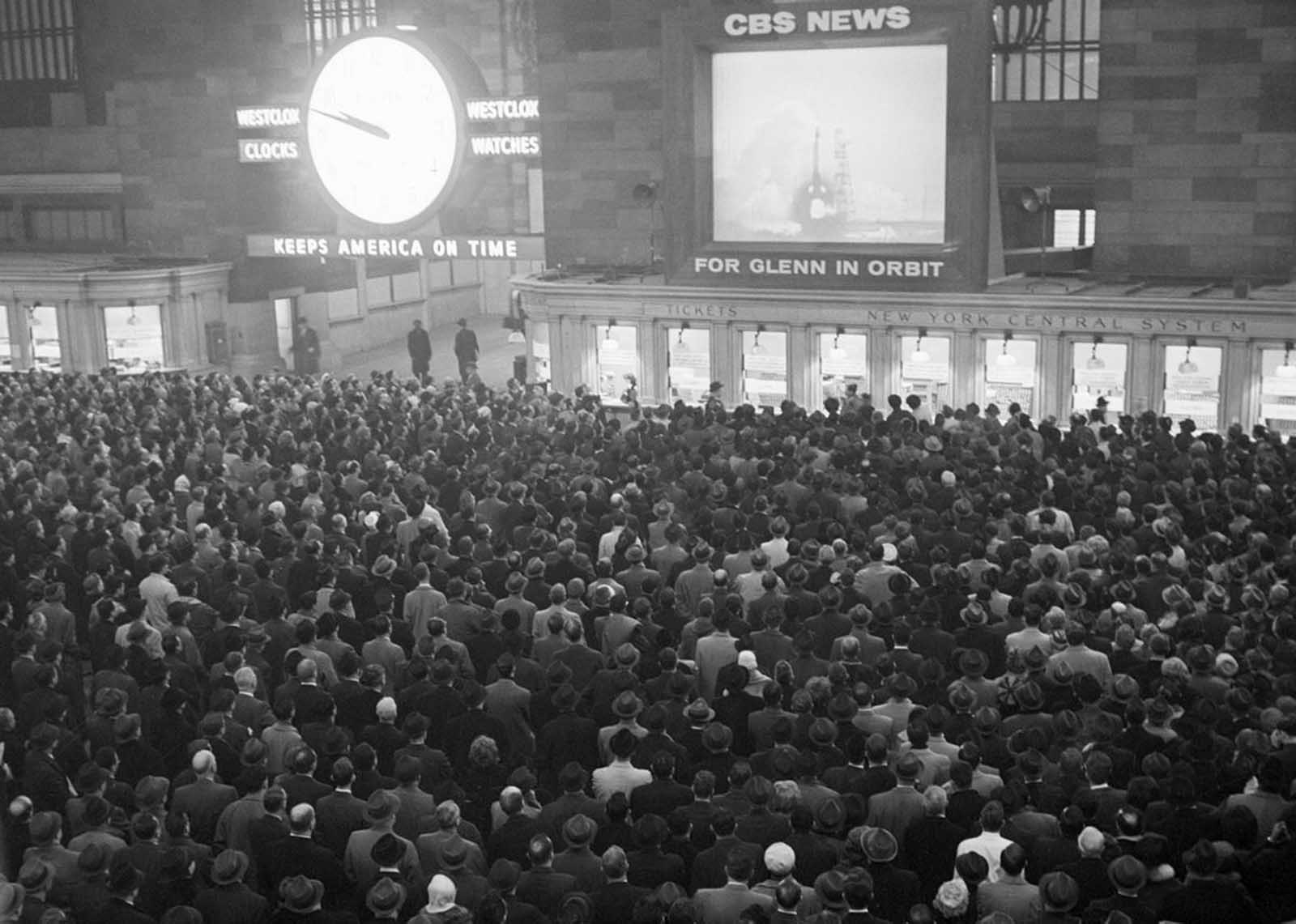 Some 5,000 workers watch the launching of astronaut John H, Glenn Jr. into orbit around the world on a huge television screen in Grand Central Terminal, on February 20, 1962.