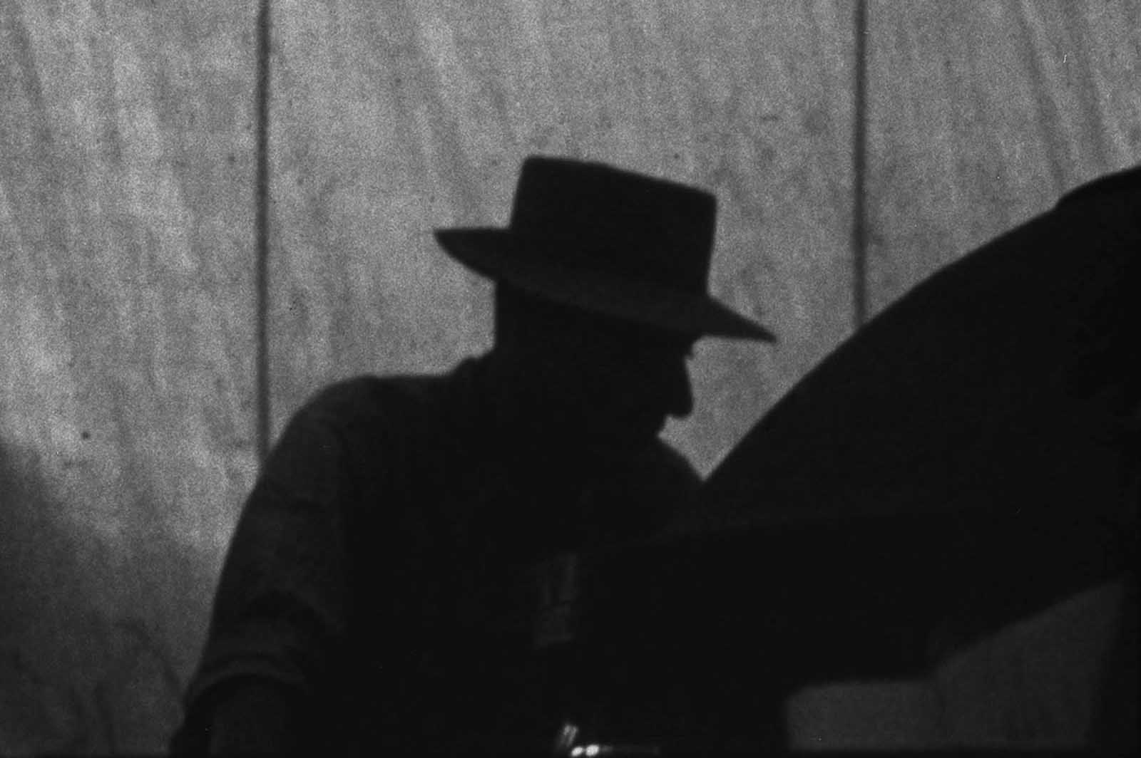 Los Alamos director J. Robert Oppenheimer is seen in silhouette as he oversees final assembly of the Gadget at the Trinity test site in July of 1945.
