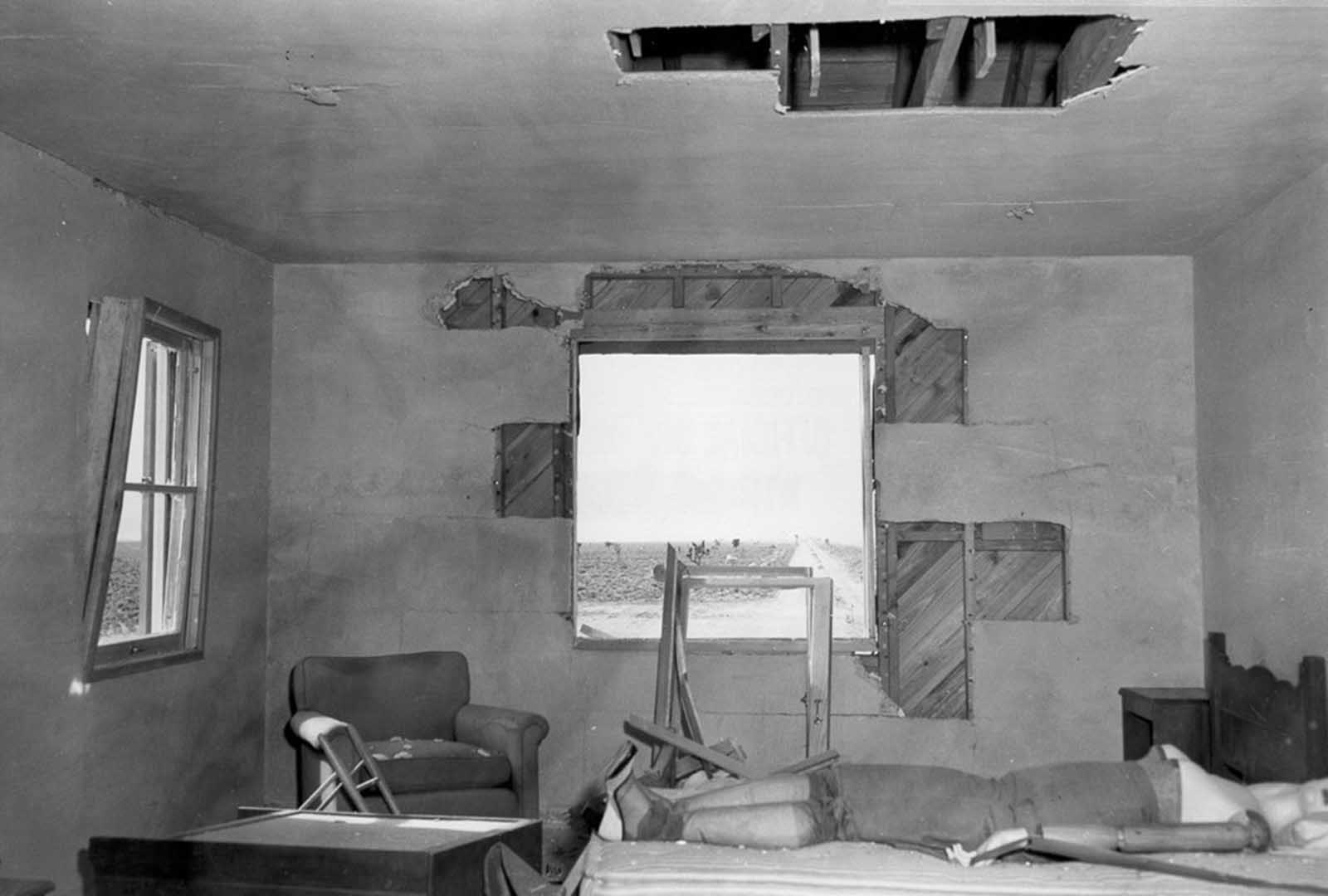 (2 of 2) After the blast, a damaged bedroom, window and blankets missing, resulting from a test during an atomic blast on March 17, 1953.