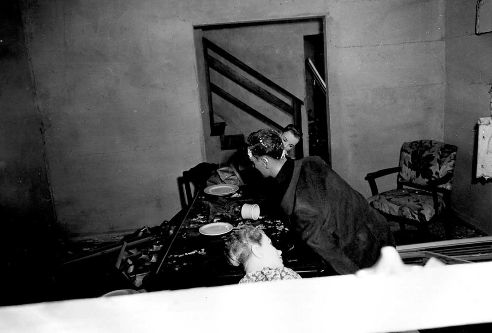 (2 of 2) After the blast, mannequins lie strewn about the room, their “dinner party” interrupted violently by an atomic blast on March 17, 1953.