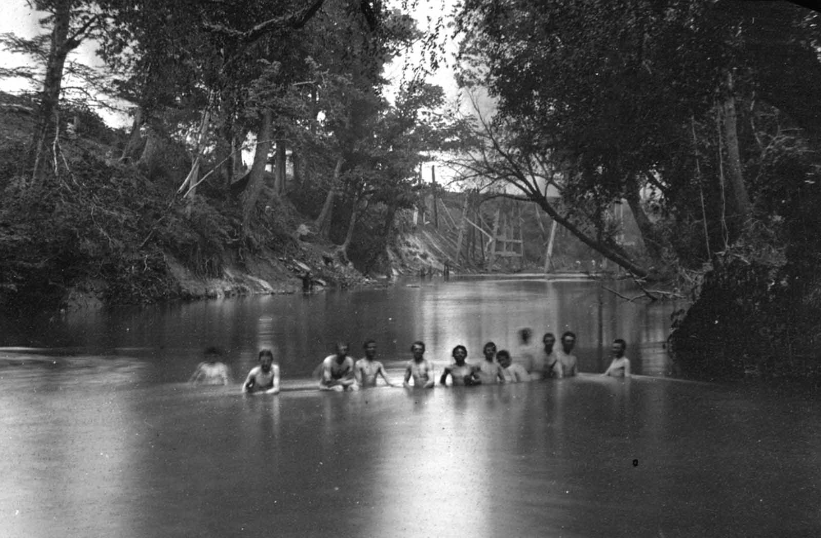 Soldiers bathing in the North Anna River, Virginia, in May of 1864. The ruins of Richmond & Fredericksburg railroad bridge are visible in the distance.