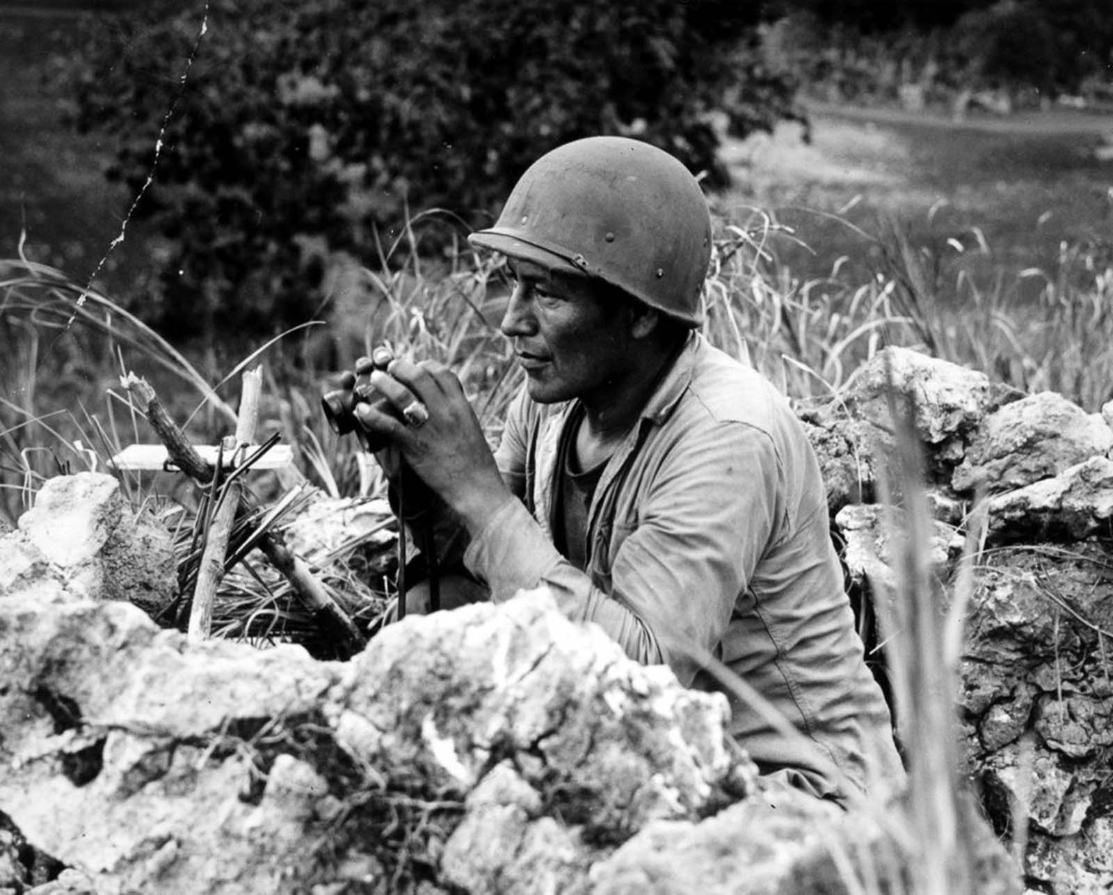Carl Nelson Gorman, one of the original 29 Navajo code talkers, tracks enemy movements on Saipan. 1944.