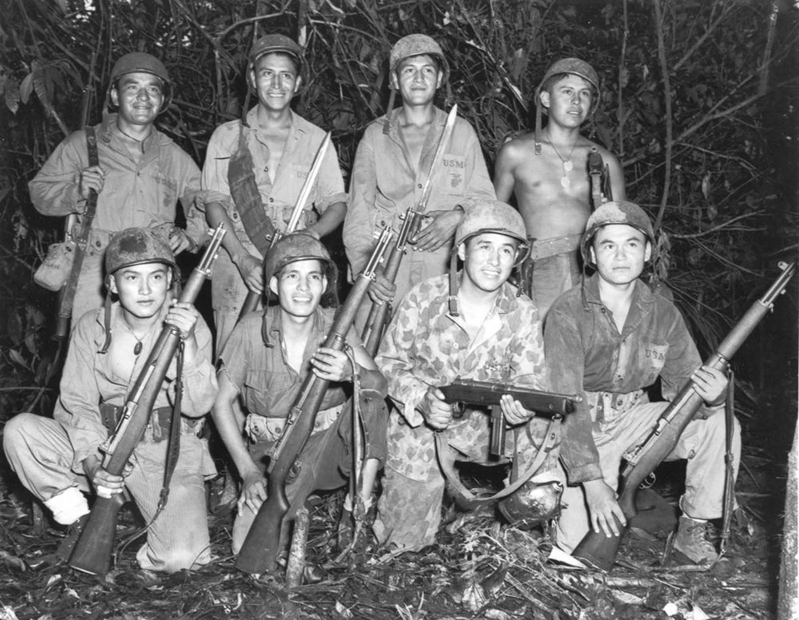Code talkers with a Marine signal unit on Bougainville. Front row, left to right: Privates Earl Johnny, Kee Etsicitty, John V. Goodluck, and Private First Class David Jordan. Back row: Privates Jack C. Morgan, George H. Kirk, Tom H. Jones, and Corporal Henry Bake, Jr. December, 1943.