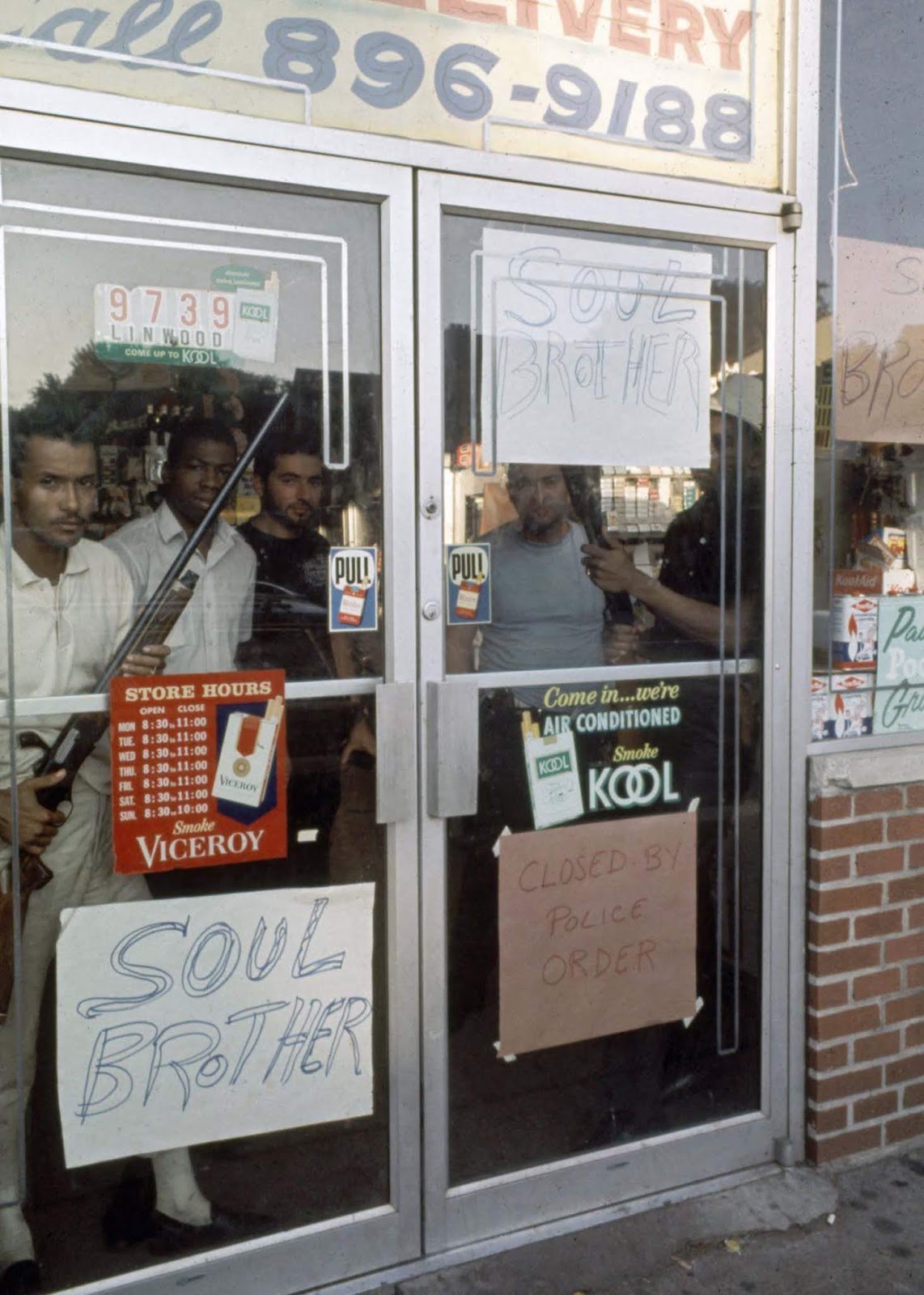 African-American store owners protecting their store with rifles.