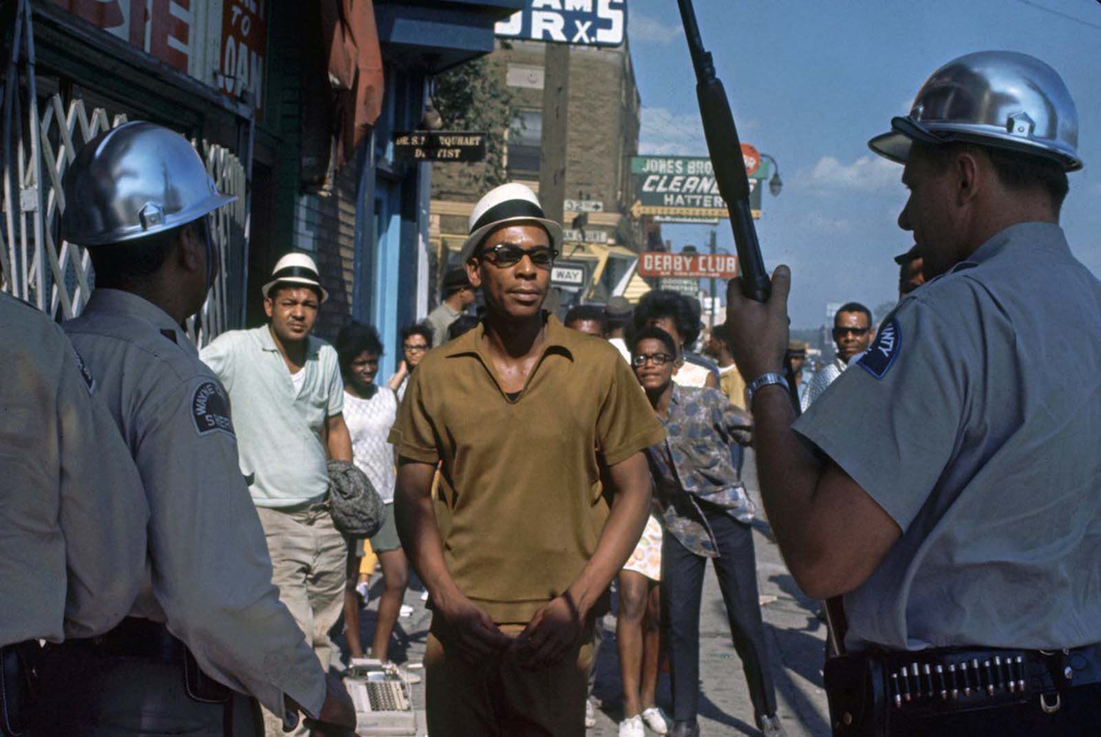 Detroit police officers confronting African-American people in the streets.