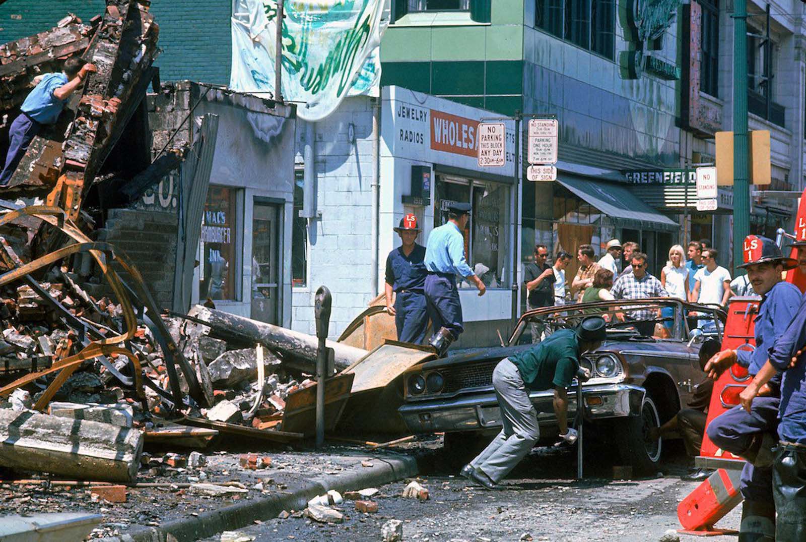 Firemen and civilians starting to clear debris.