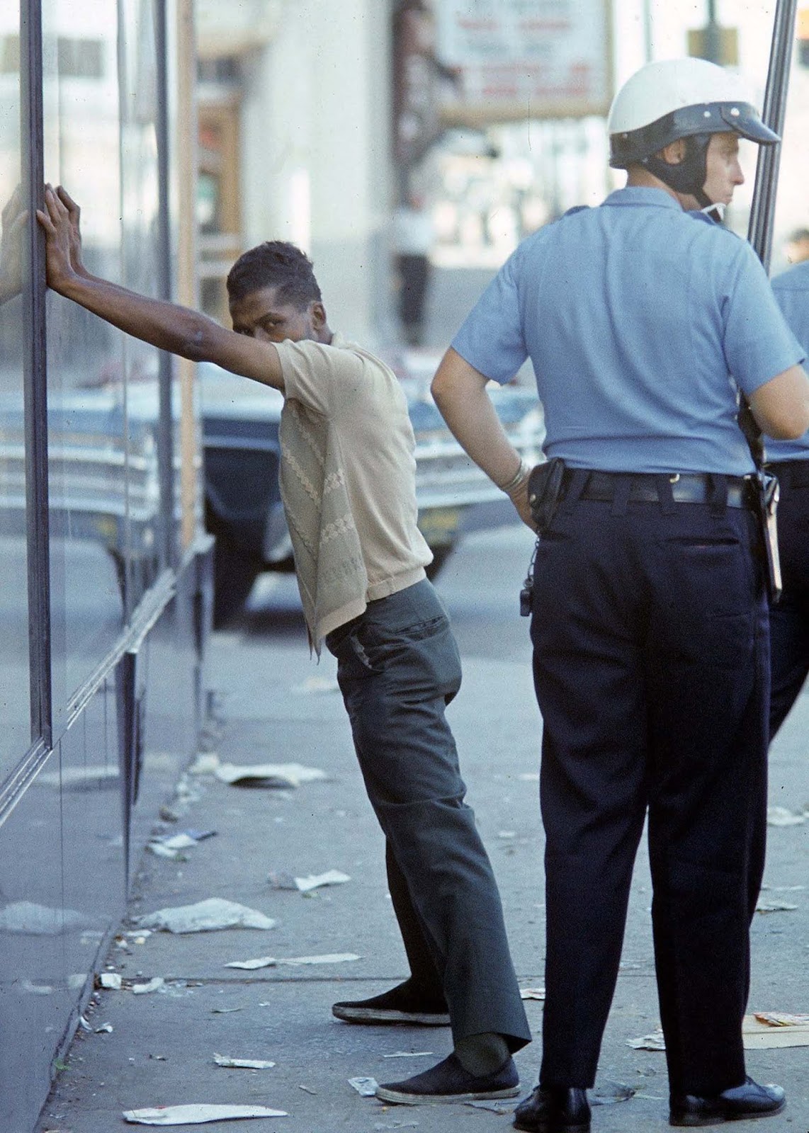 Police officer arresting an African American.
