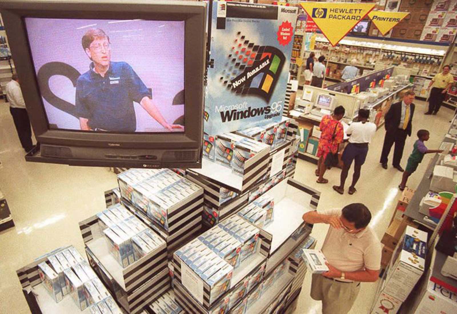 Microsoft CEO Bill Gates speaks on a television above a Windows 95 display at a store in Vienna, Virginia.
