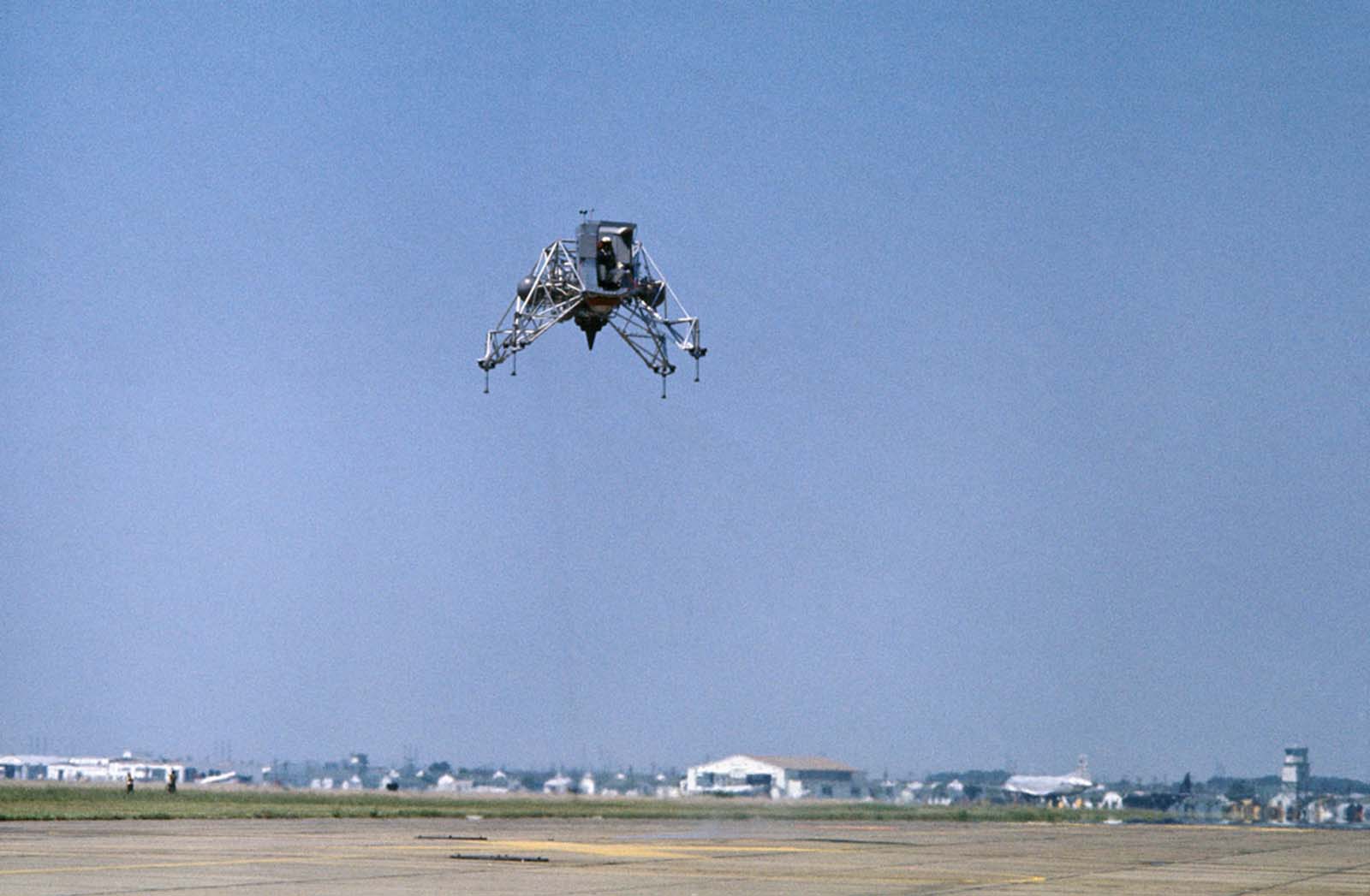 Original caption: Practicing for the Big One at Ellington A.F.B., Texas. Apollo 11 Commander Neil Armstrong flies the Lunar Landing Training Vehicle in preparation for the lunar-landing attempt in July. The flight lasted for five minutes, during which Armstrong made two takeoffs and landings. He flew the craft to an altitude of some 300 feet.