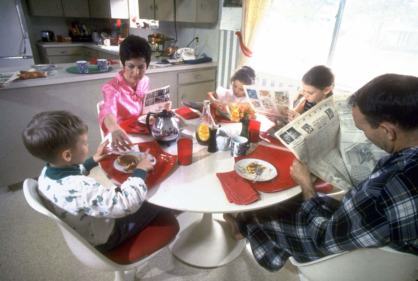 From a Life magazine series on the Apollo astronauts at home, a photo of Michael and Pat Collins and their children enjoying a relaxing pancake breakfast in March 1969.
