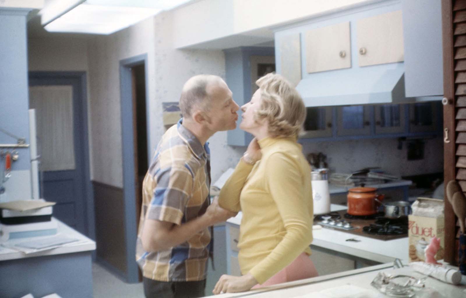 Buzz and Joan Aldrin share a kiss in the kitchen of their Texas home.