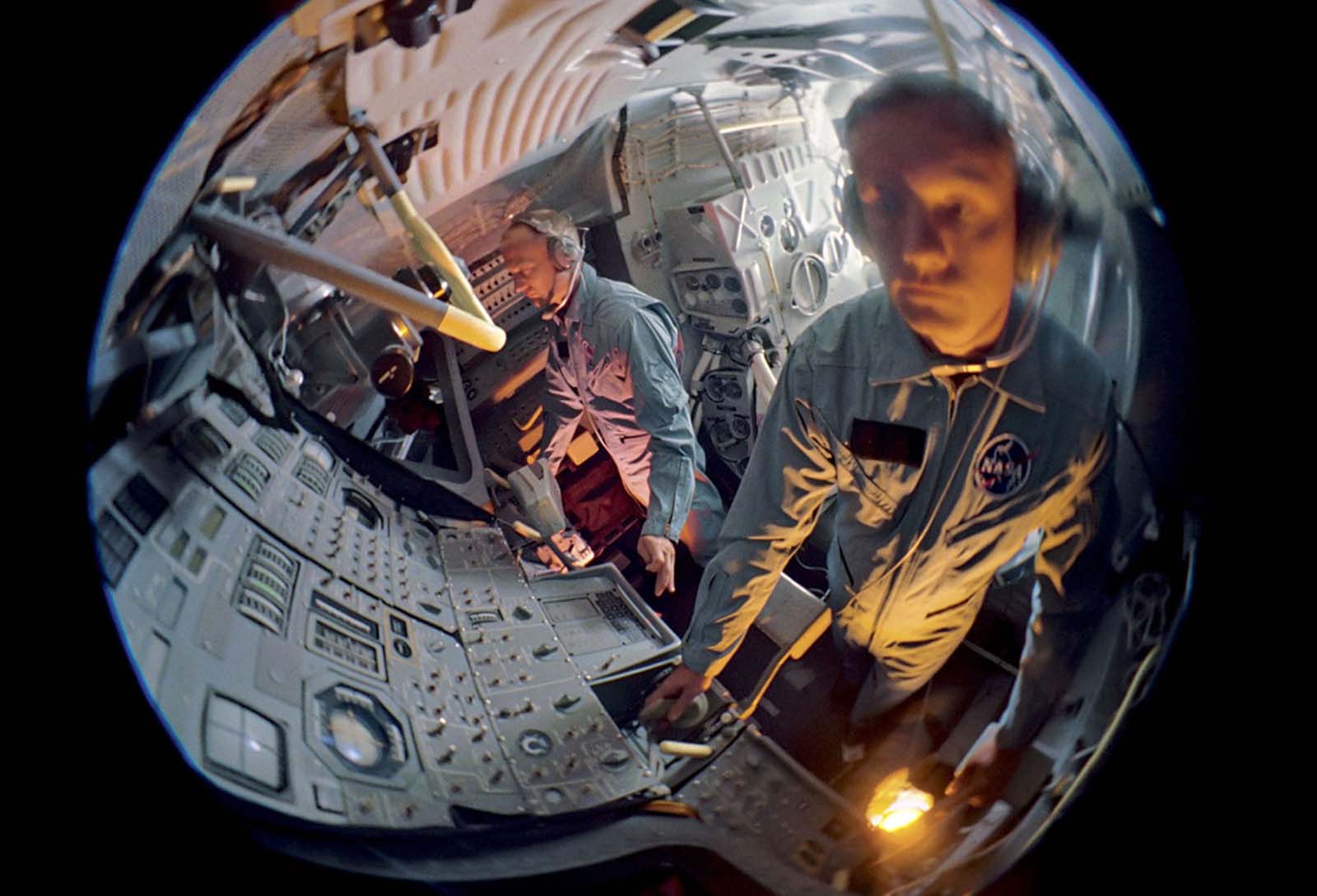 A fish-eye view of the astronauts Buzz Aldrin and Neil Armstrong as they train in a mock-up lunar module.