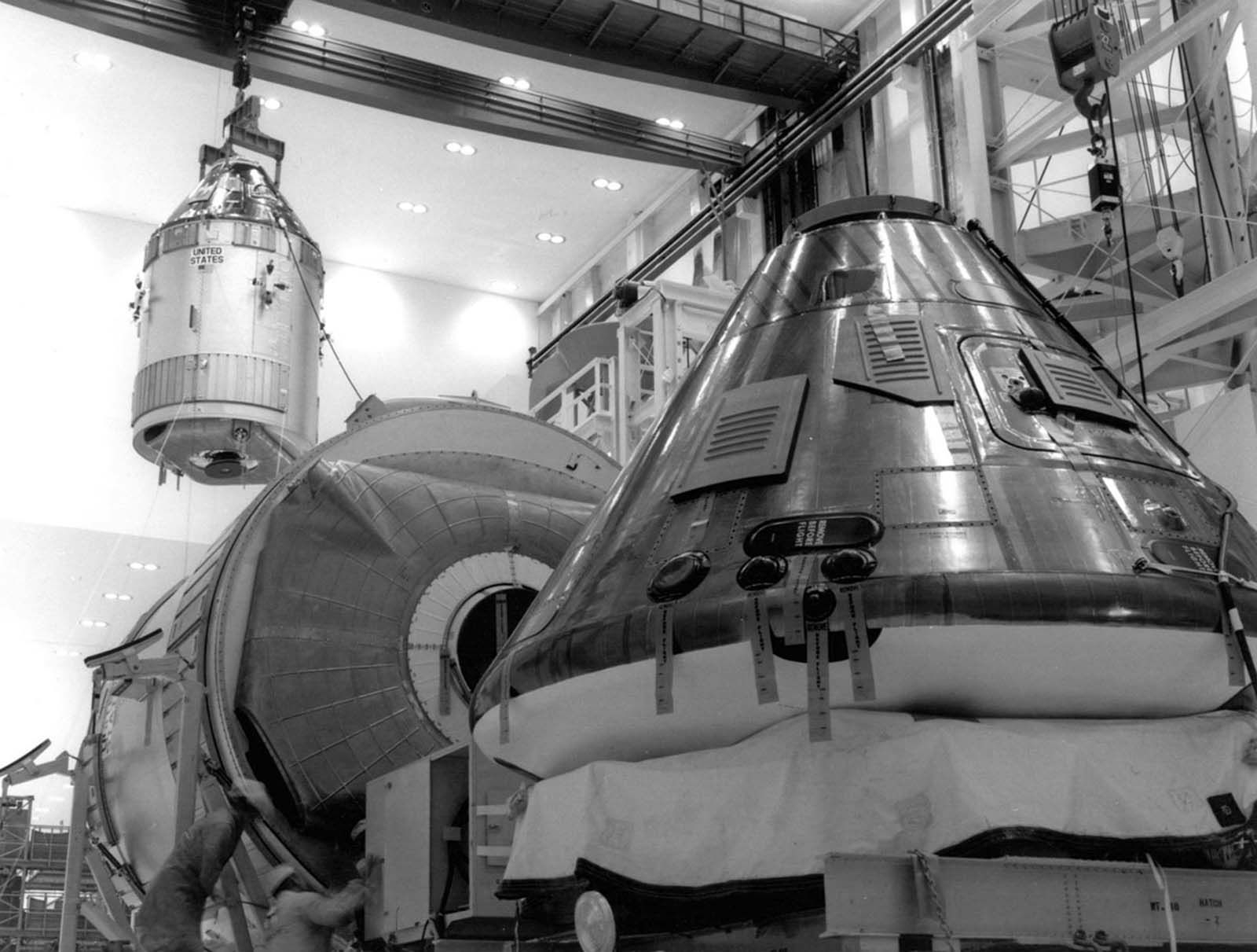 The command module and service module for the Apollo 11 mission are moved to the work stand on April 1, 1969, in preparation for the first manned lunar landing.