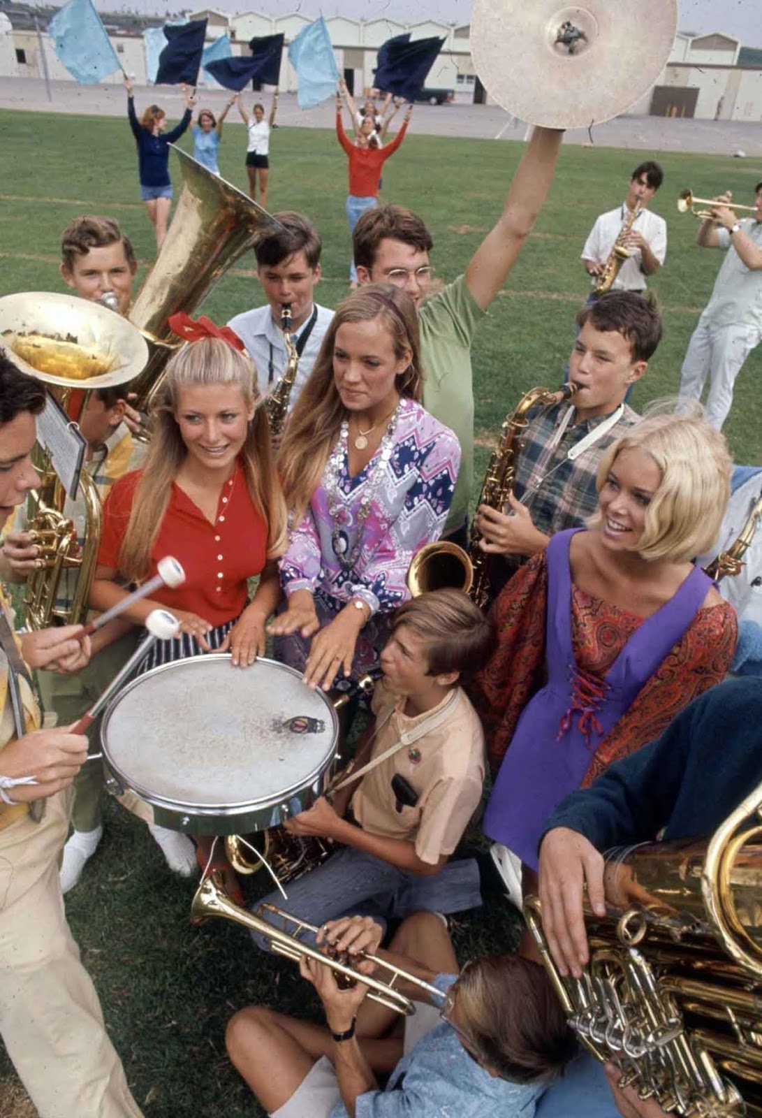 A high school student marching band and a trio of women students.