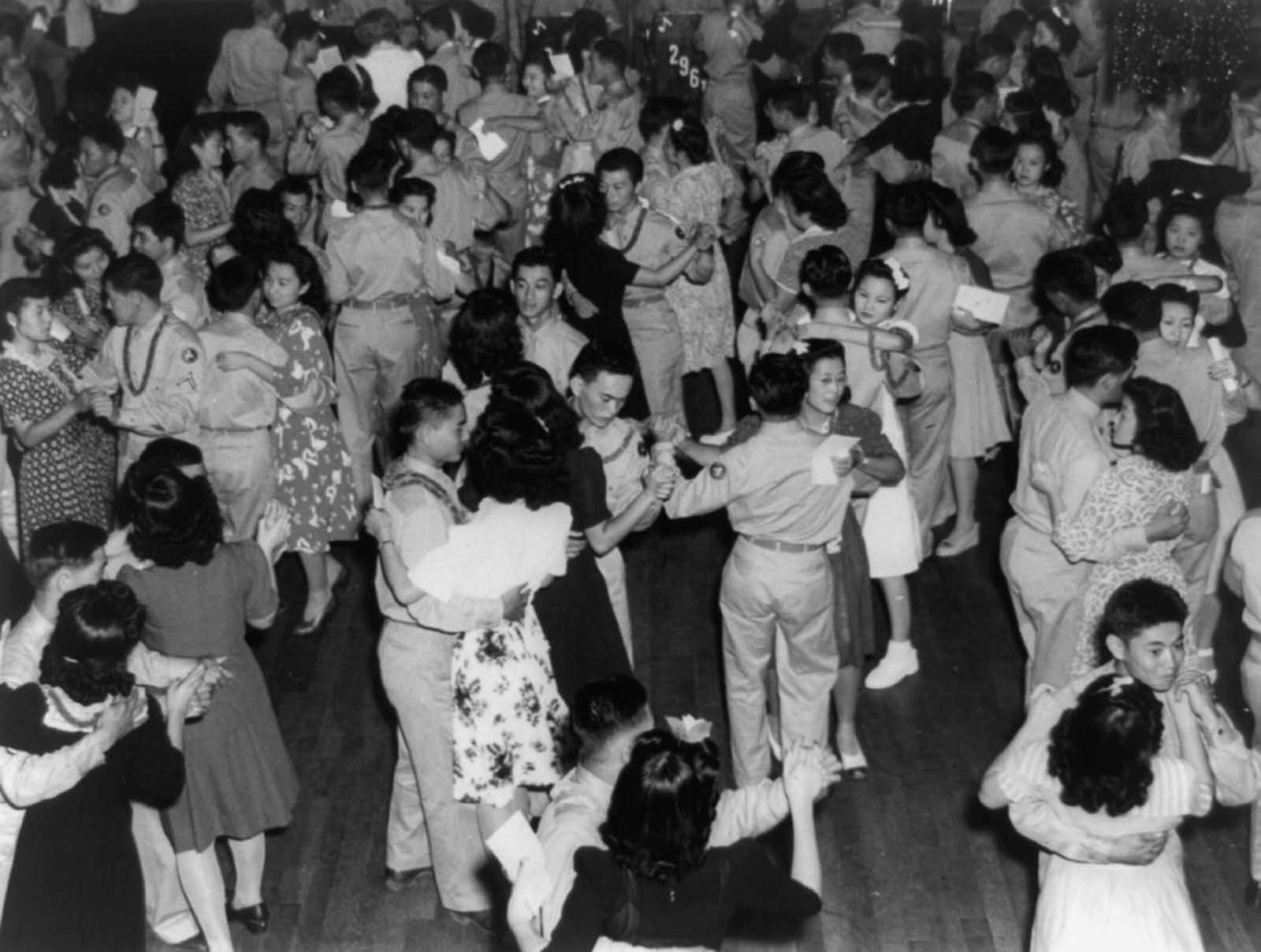 Soldiers of the 442nd dance with Japanese-American women from Jerome and Rohwer Relocation Center at Camp Shelby, Mississippi. 1943.