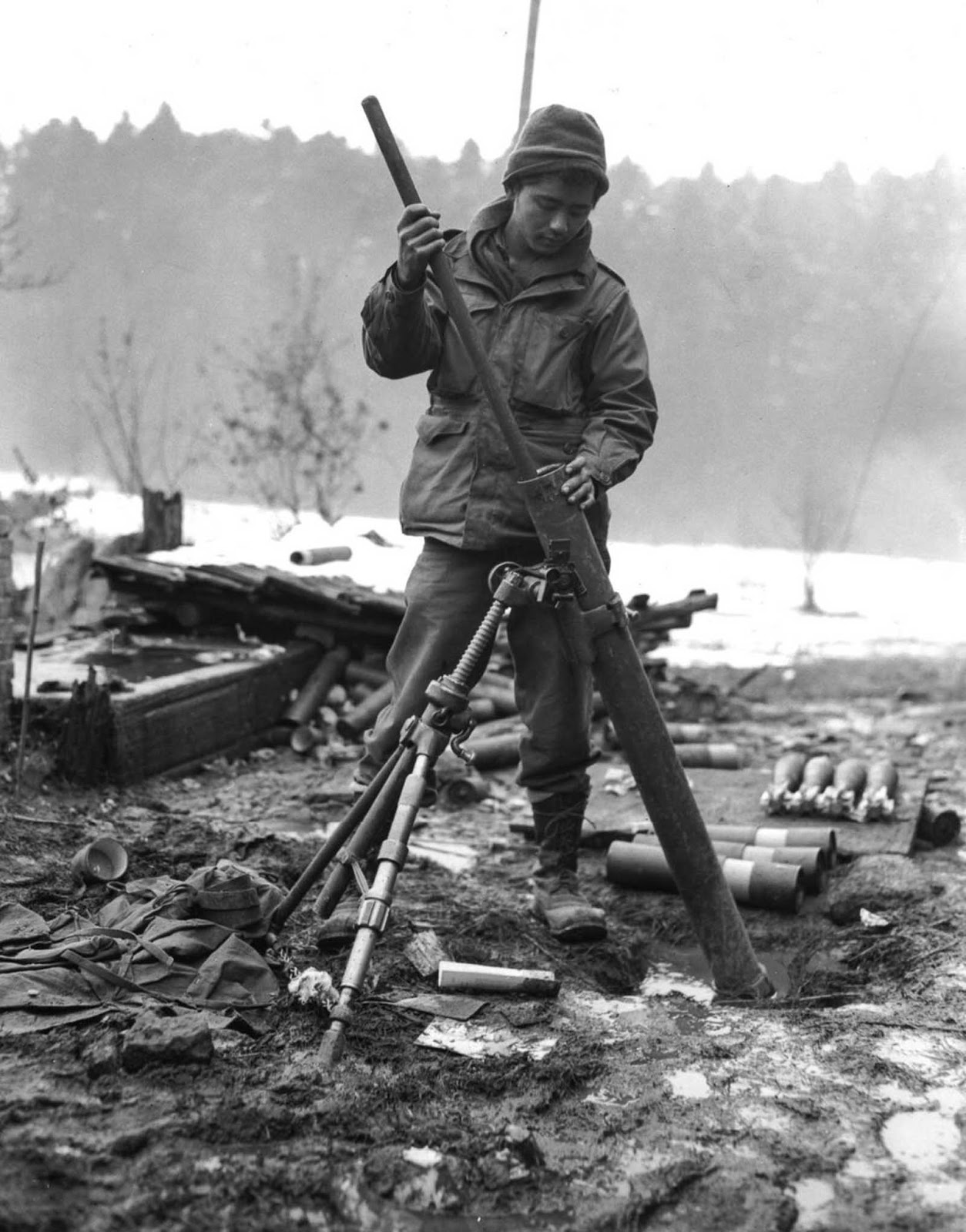 A soldier of the 442nd cleans the barrel of an 81mm mortar near St. Die, France. Nov. 17, 1944.
