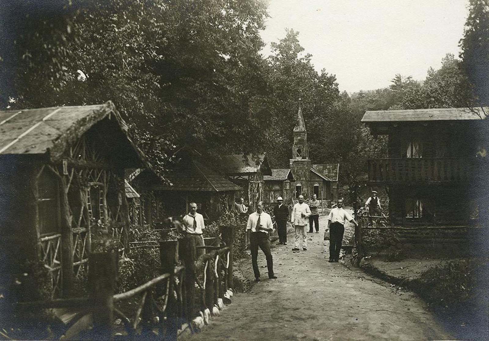 German internees pose in the village they built at the internment camp.