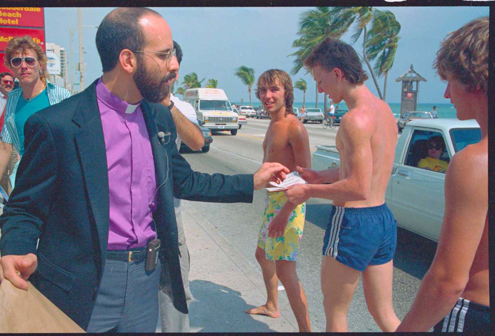 Rev. Fred Tondalo (L) passes out condoms along the highway A1A strip. 1987.
