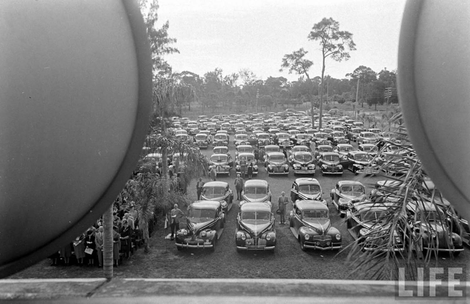 Classical cars lined up in this drive-in church.