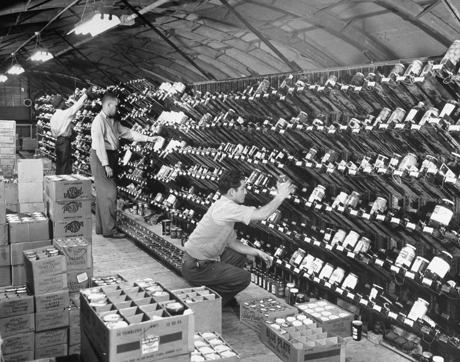 A worker stocks the grocery chutes in the Keedoozle.
