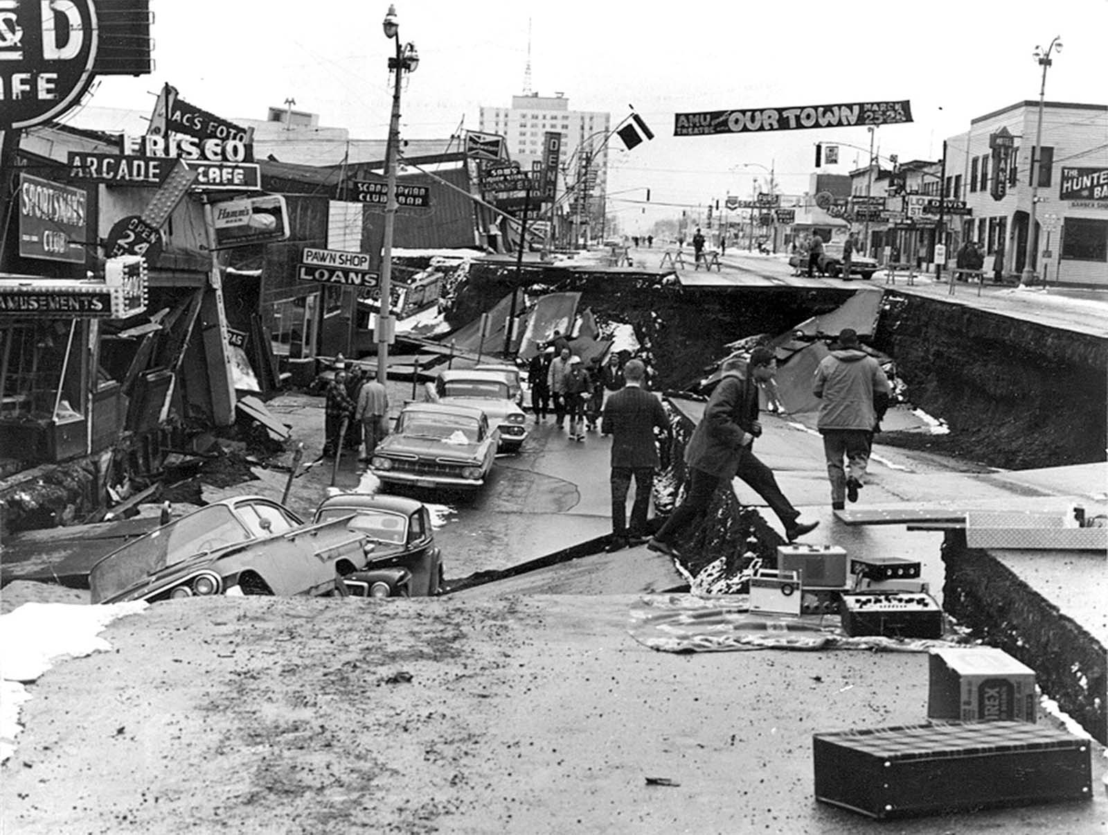 Downtown Anchorage, the collapse of Fourth Avenue near C Street, due to a landslide caused by the earthquake. Before the shock, the sidewalk on the left was at street level with the one on the right.