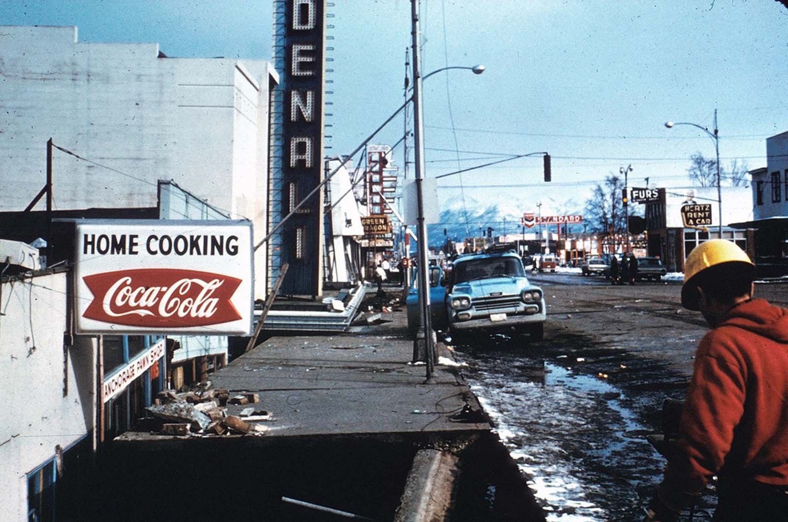 The marquee of the Denali Theater sits even with the street in Anchorage. The building's foundation subsided until the marquee came to rest on the sidewalk.