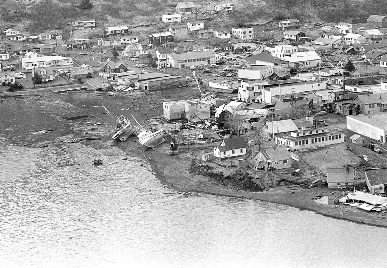 The path of destruction made by the quake in Alaska followed by a tsunami can be seen in this aerial view of Kodiak on March 29, 1964. The wave swept in from the lower left and towards upper right, pushing and smashing everything in its way.